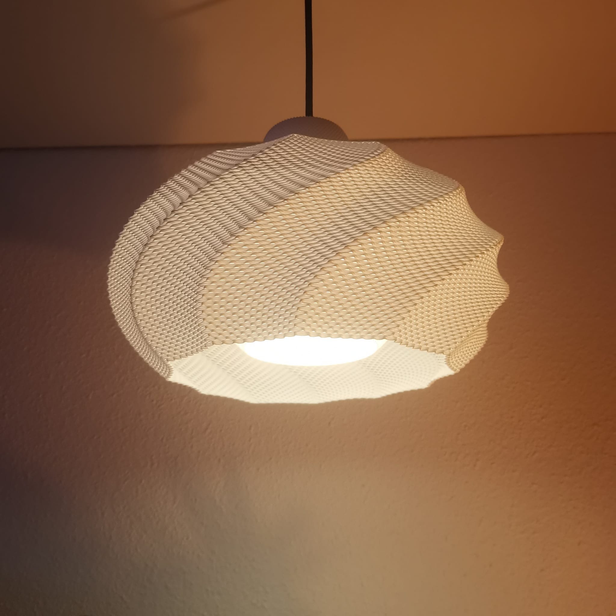 Azure Pontus Twist Glow pendant lamp with a twisting, modern design, perfect for stylish lighting in living spaces.