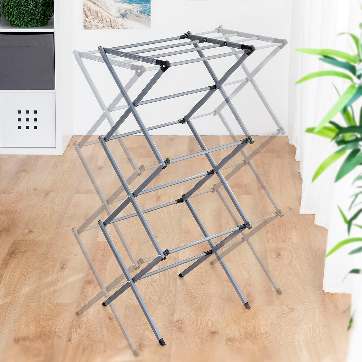 Extendable metal clothes dryer with 3 levels, compact foldable design for home laundry storage, by Bigbuy.