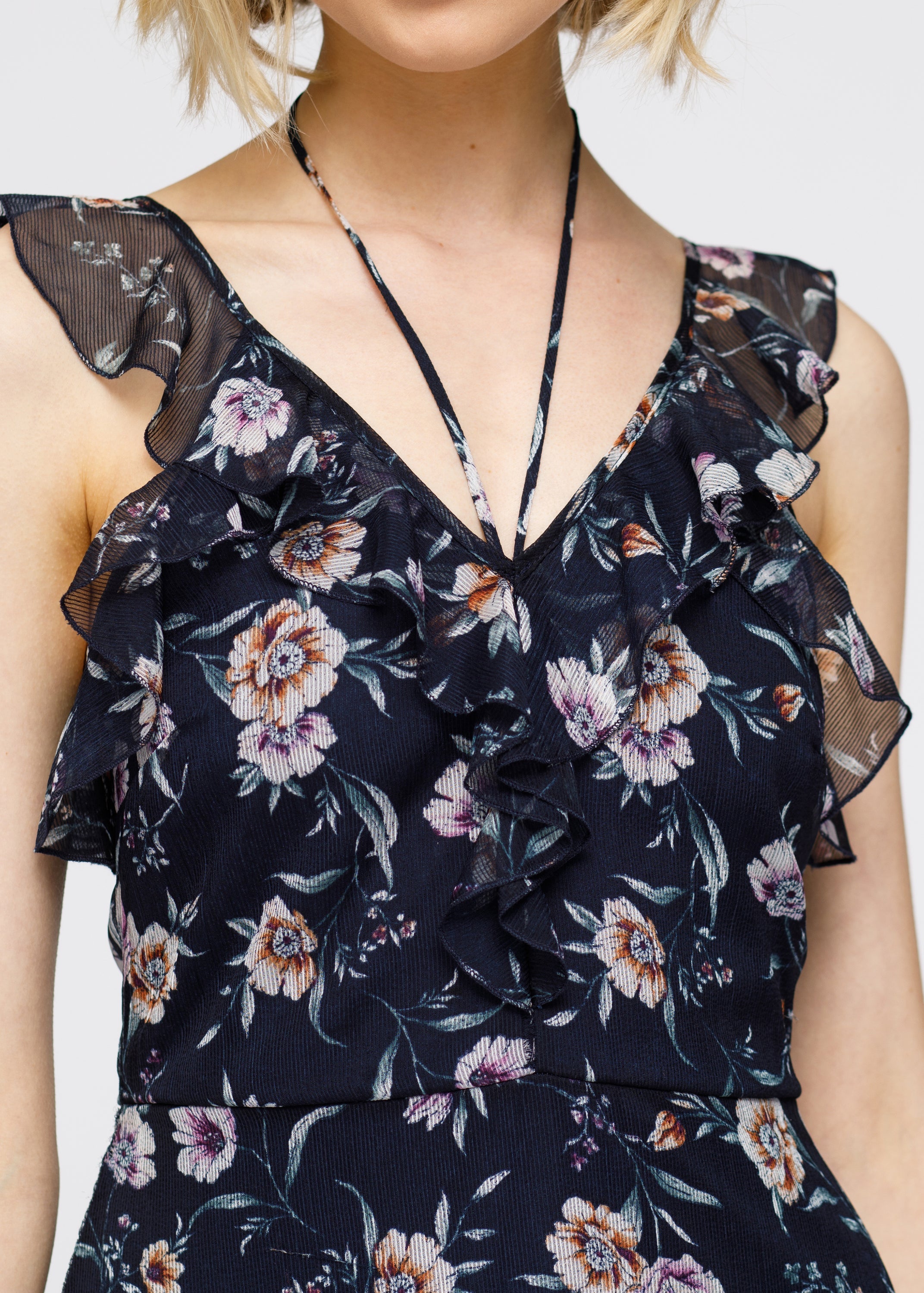 Navy wax flower mini ruffled sleeveless dress by Lemon Hera, showing a stylish sleeveless dress with ruffle details.