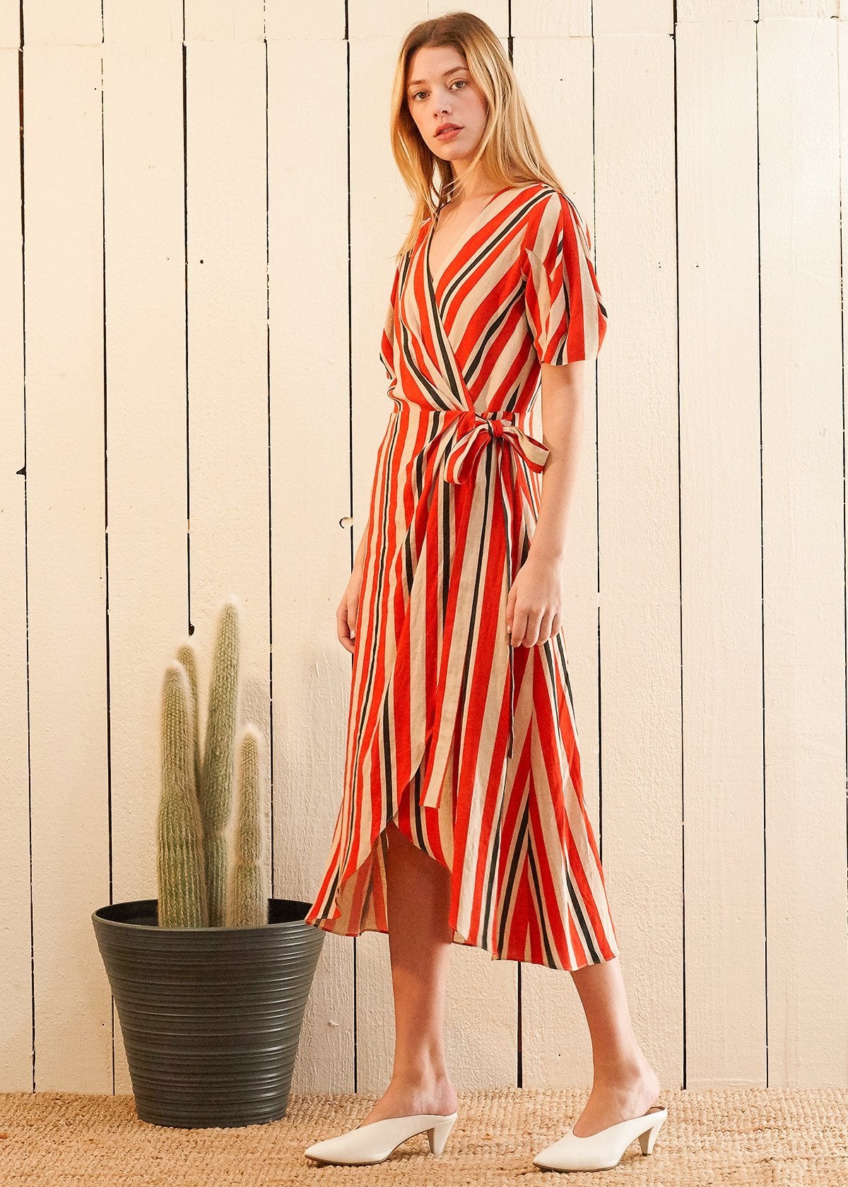 Lemon Hera puff sleeve wrap dress in Poppy Multi with floral pattern, featuring a fitted waist and flowing skirt.