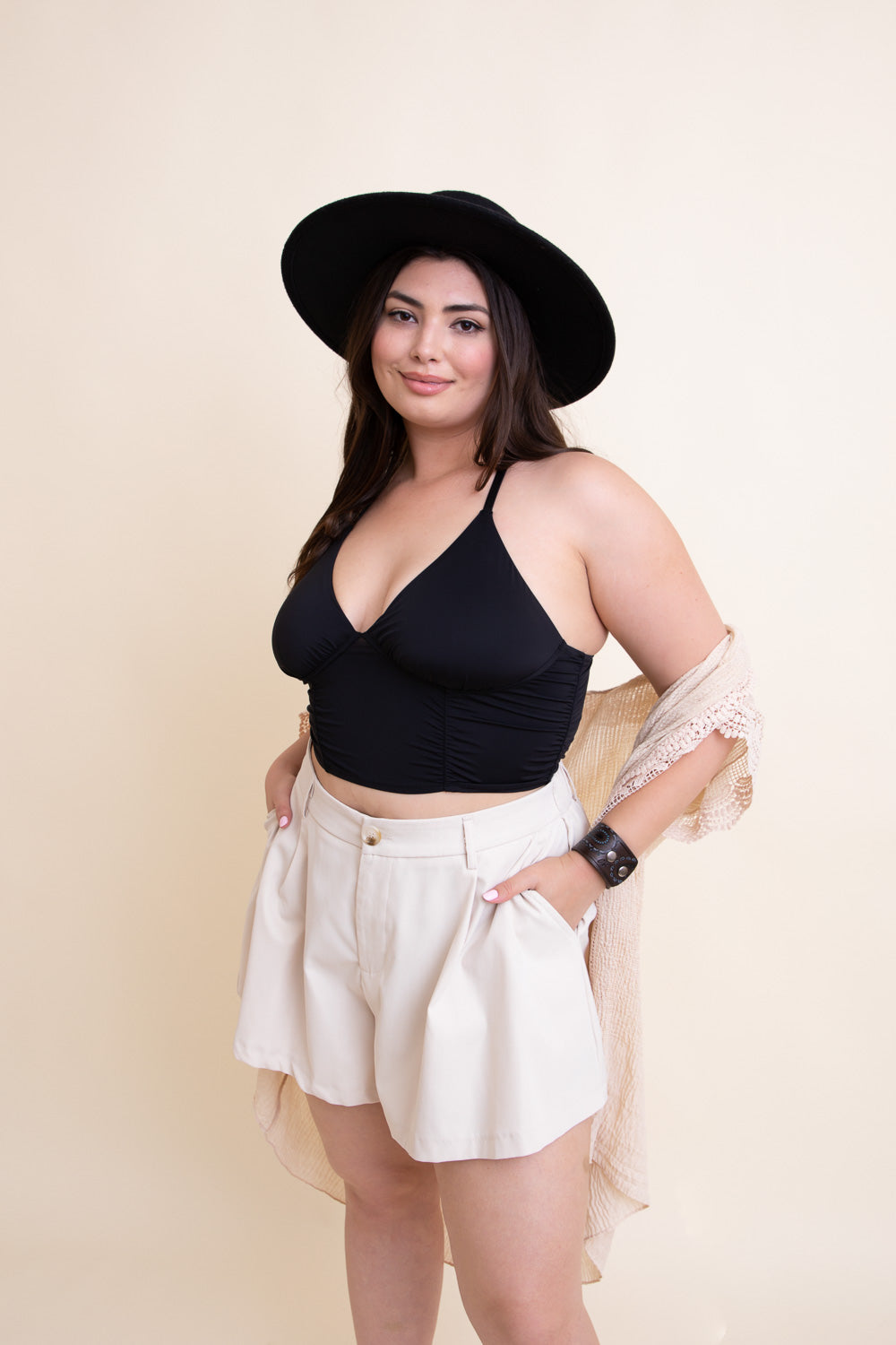 Black ruched bralette tank top by Periwinkle Aether, featuring a fitted design and adjustable straps.
