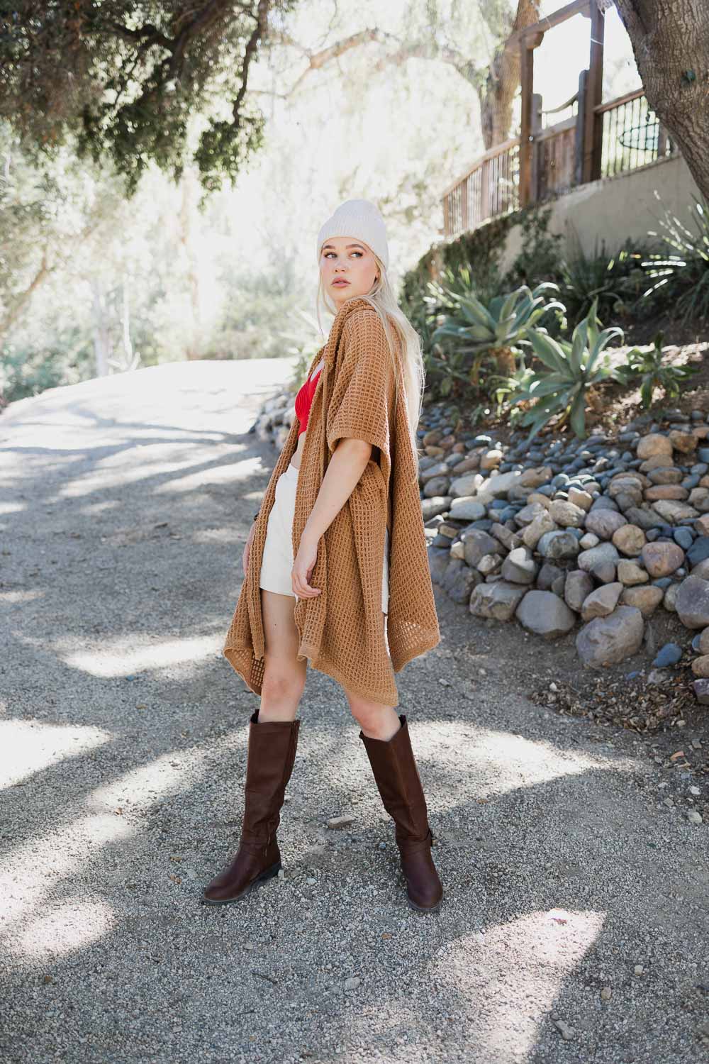 Camel-colored cozy soft waffle hooded ruana from Periwinkle Aether, featuring a textured waffle knit and relaxed fit.