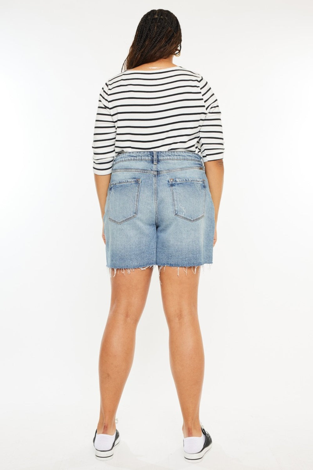 Raw hem high waist denim shorts by Kancan, styled with automotive-themed accessories, showcasing a casual, edgy look.