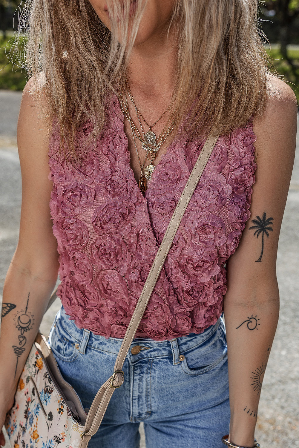 Floral textured V-neck sleeveless bodysuit by Byzantium Bay, featuring a wrapped design and fitted silhouette.