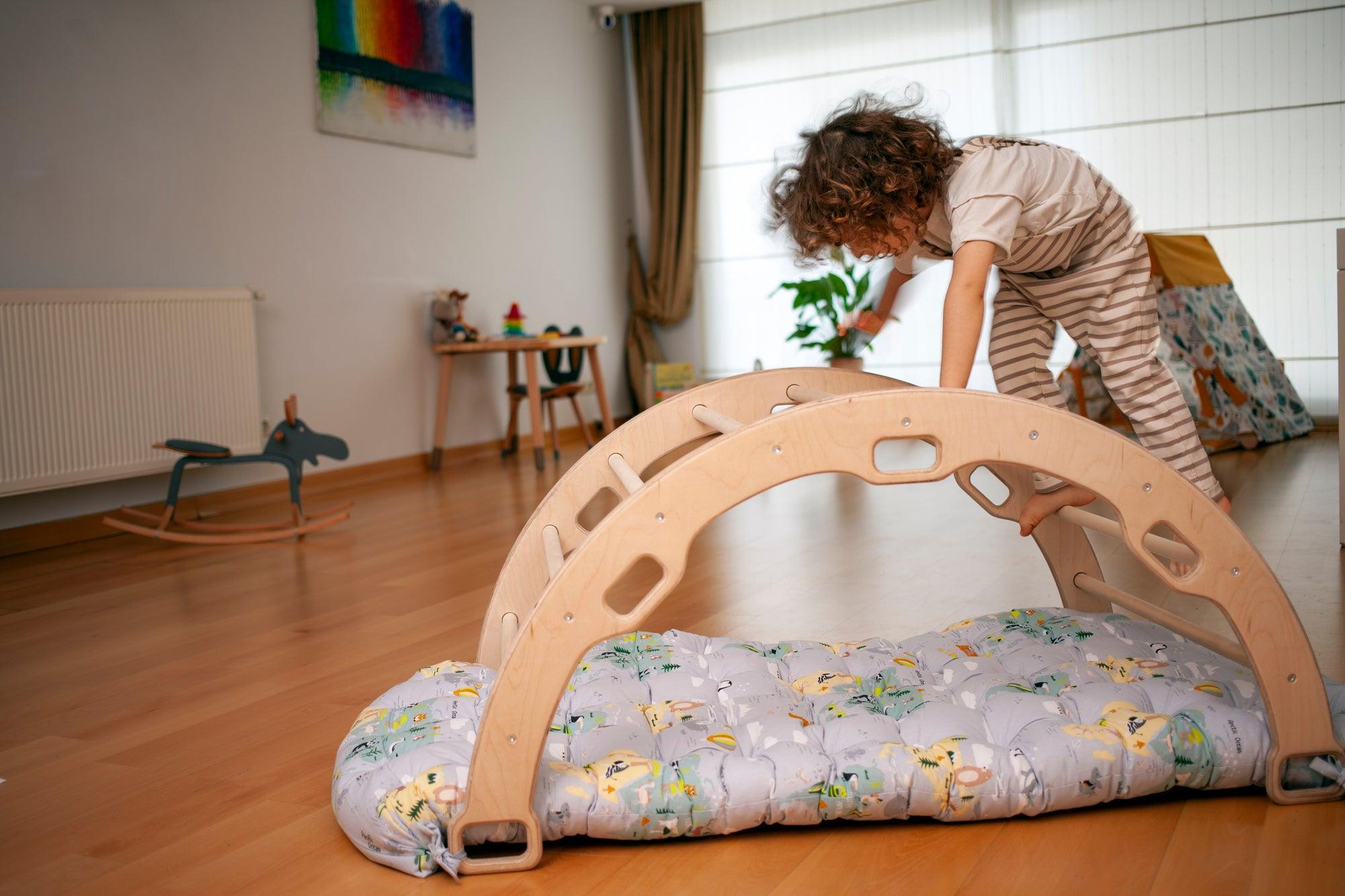 Red Oceanus climbing arch with map pattern pillow, a colorful rock climbing-themed piece of furniture with vibrant fabric.