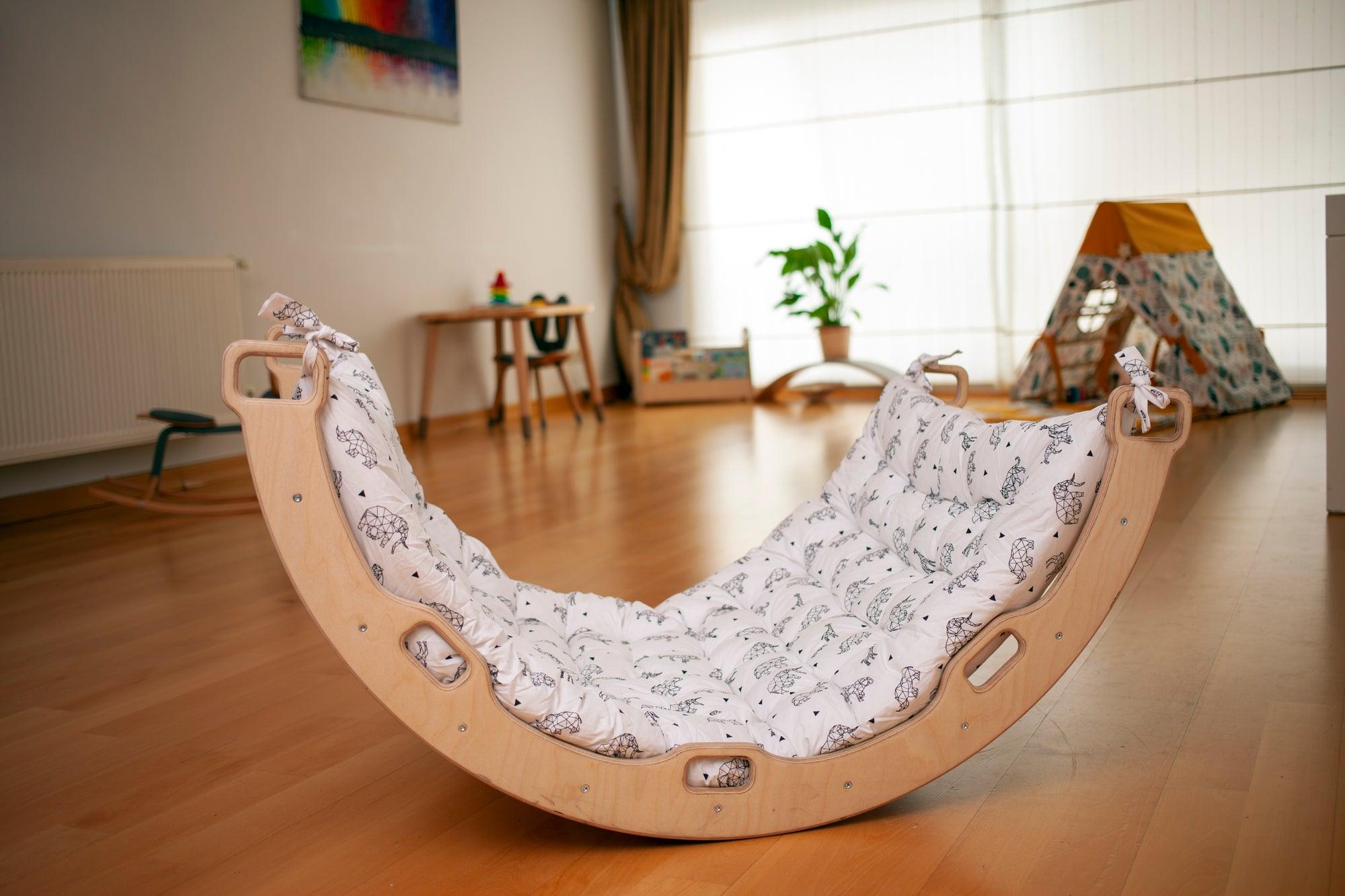 Red Oceanus climbing arch with origami pattern pillow, a stylish furniture piece featuring a unique sculptural design and decorative cushion.