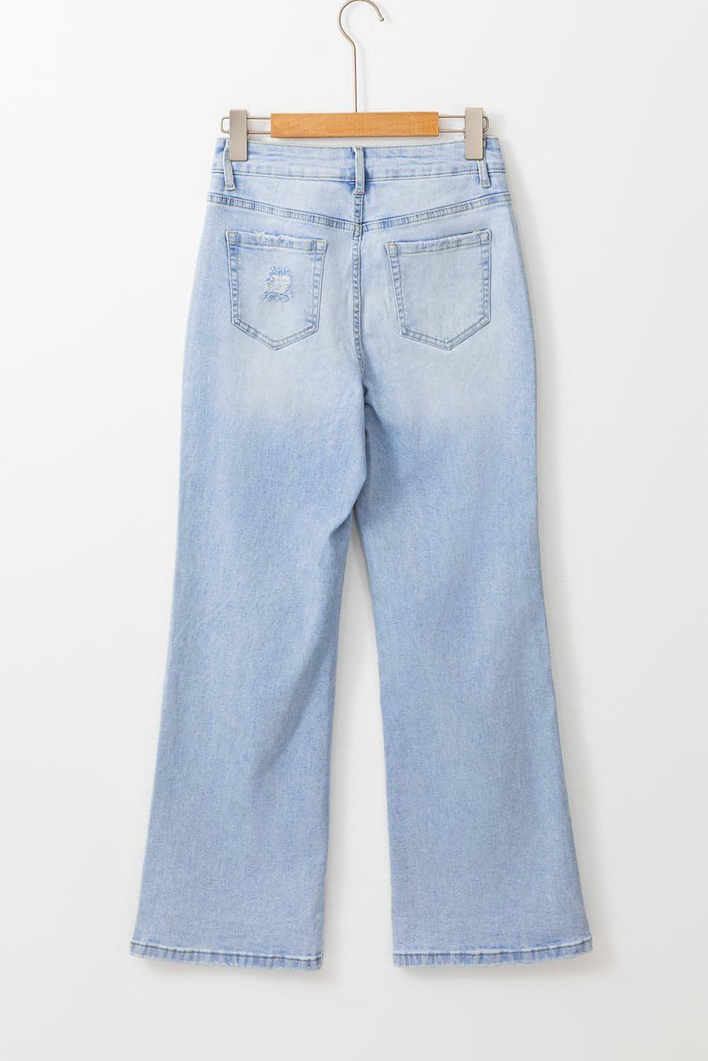 Carmine Juneberry Beau Blue vintage light wash distressed flare jeans showing frayed hems and classic five-pocket style.