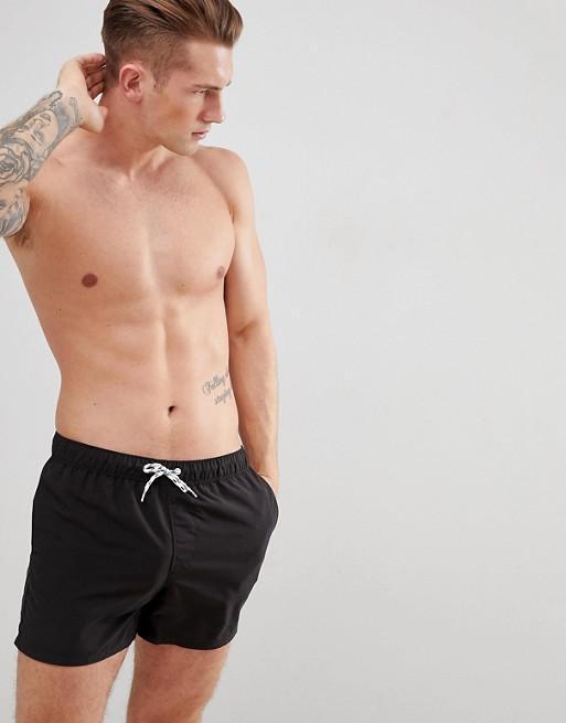 Black Sky Felix swim shorts with a relaxed fit, laid flat to show the waistband and fabric texture.