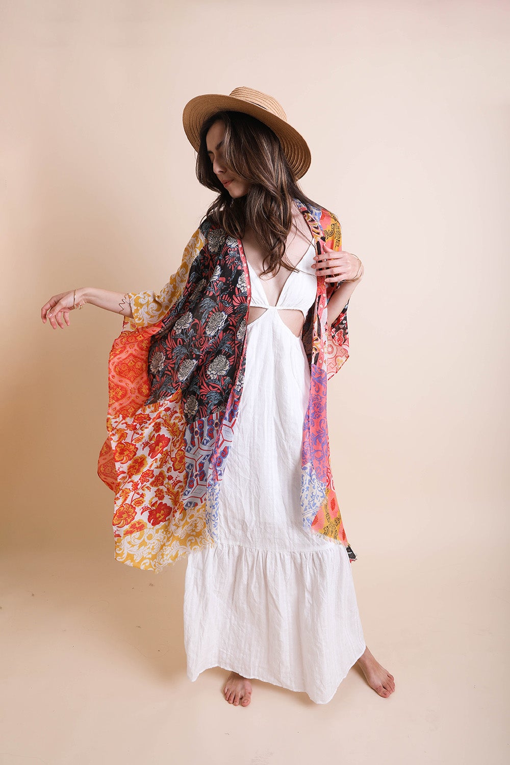 Colorful boho patchwork kimono from Periwinkle Aether, featuring flowing fabric and intricate patchwork design.