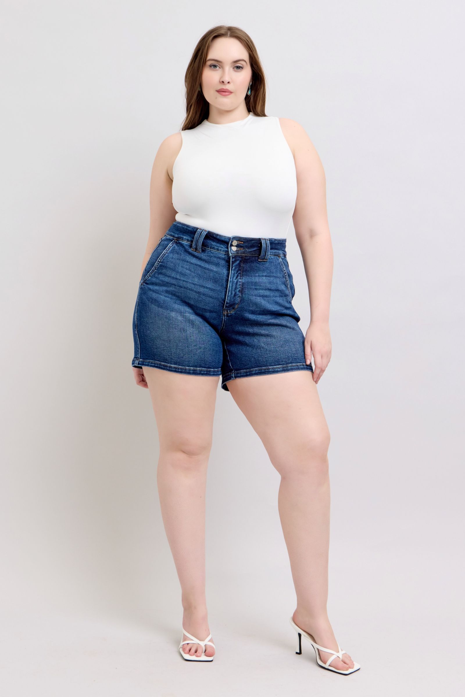 Judy Blue plus size denim shorts with double button waistband, featuring classic blue denim and frayed hem detail.