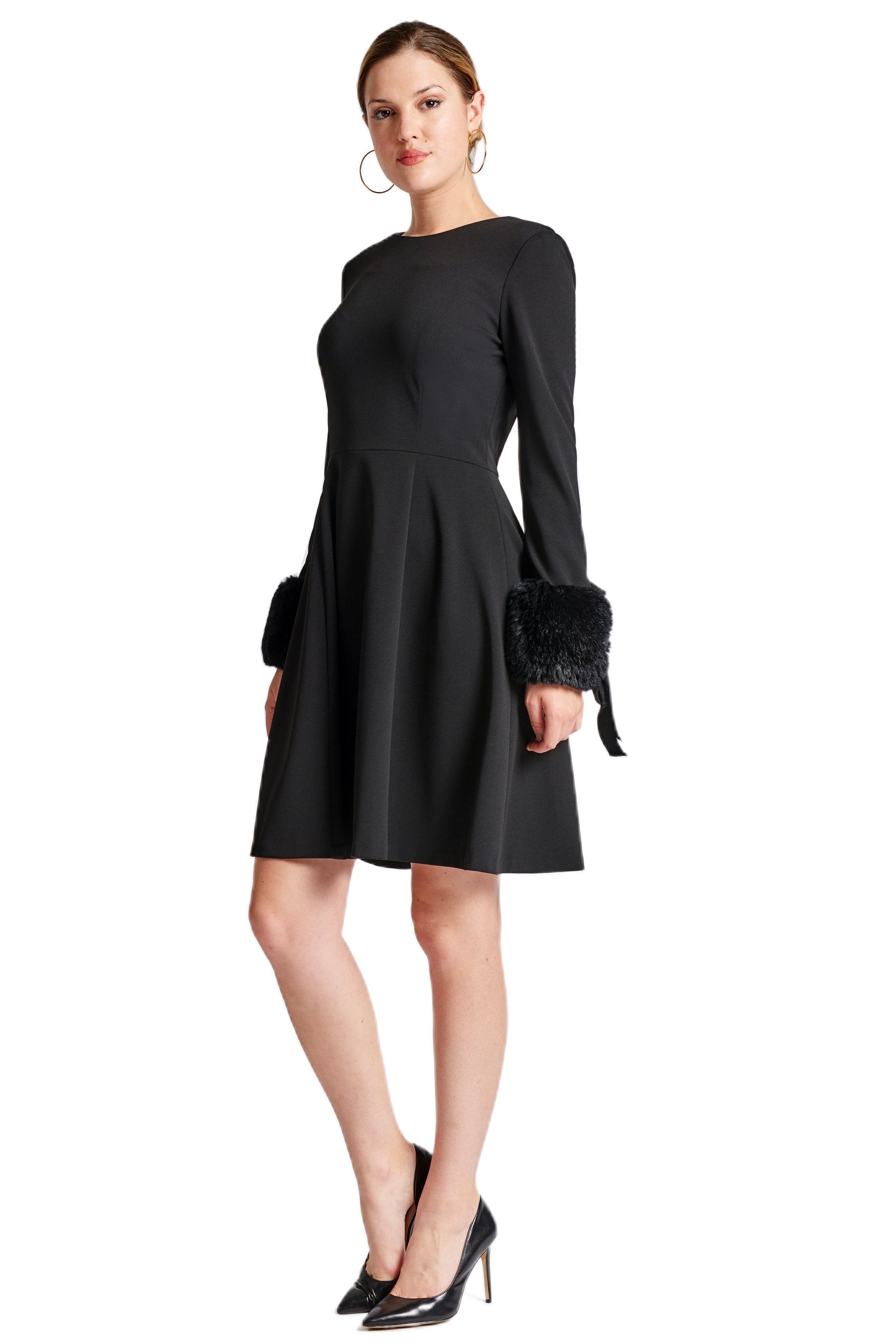 Black Caroline Dress by Peach Dionysus featuring long sleeves, fit and flare silhouette, and faux fur detail, shown from the side.
