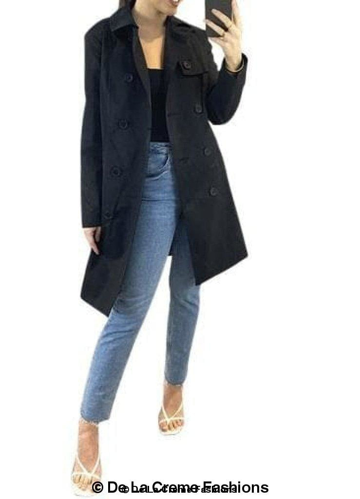 Cotton blend belted trench coat by Rose Eleusis featuring classic double-breasted design and waist belt, shown on model.