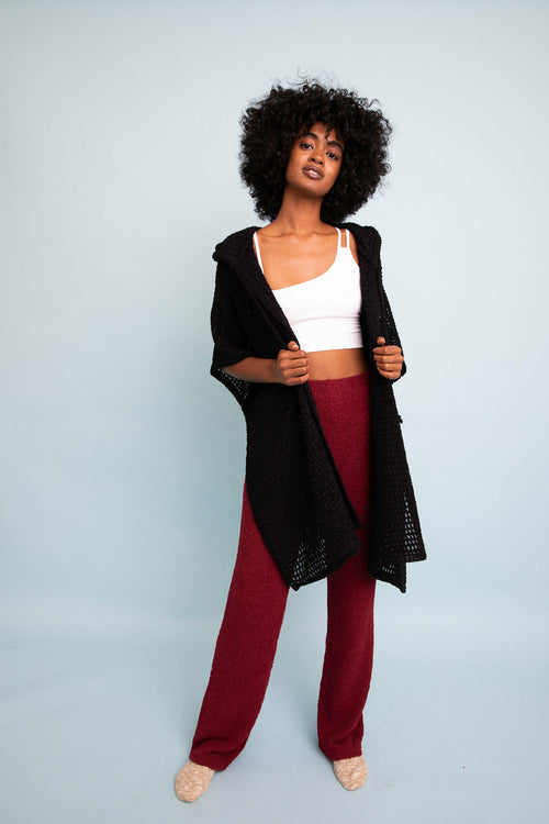 Black cozy soft waffle hooded ruana by Periwinkle Aether, featuring a relaxed fit and casual, warm accessory style.