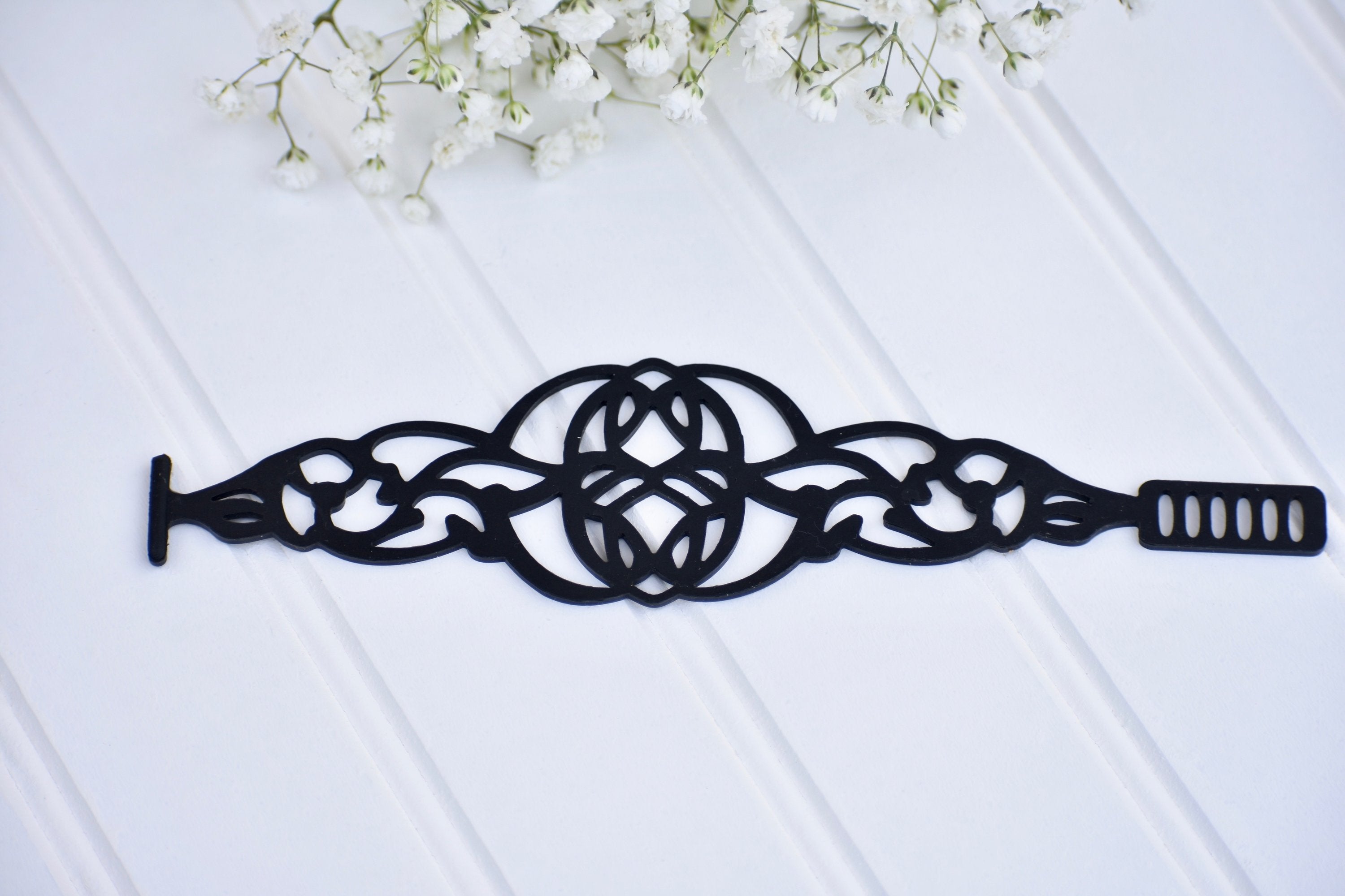 Black Rose Brave Bracelet, stylish jewelry piece featuring a sleek design with intricate details in silver-tone metal.