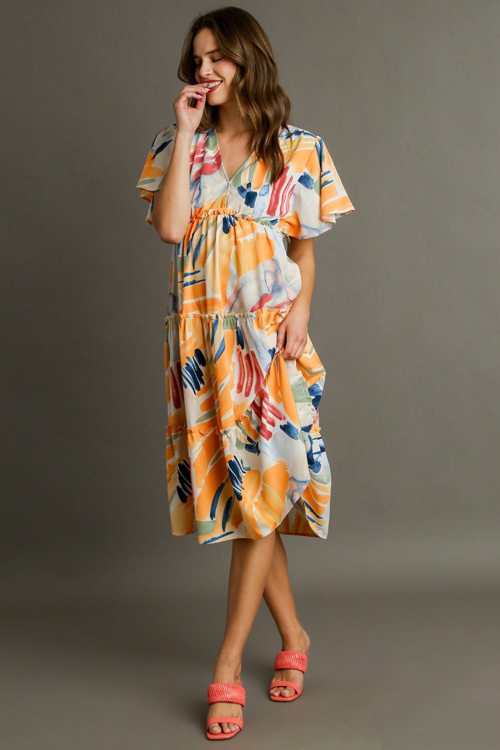 Colorful abstract print Umgee flutter sleeve frill tiered midi dress, showcasing its layered design and flowing fabric.