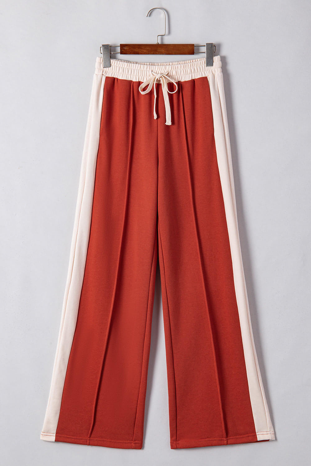 Carmine Juneberry flamingo color block drawstring high waist wide-leg pants displayed on a hanger.