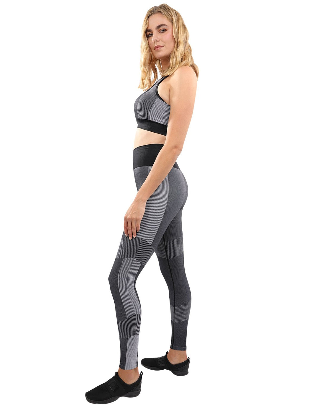 Black Lazurite Arleta seamless leggings and sports bra set for women, shown on a model in a fitness pose.