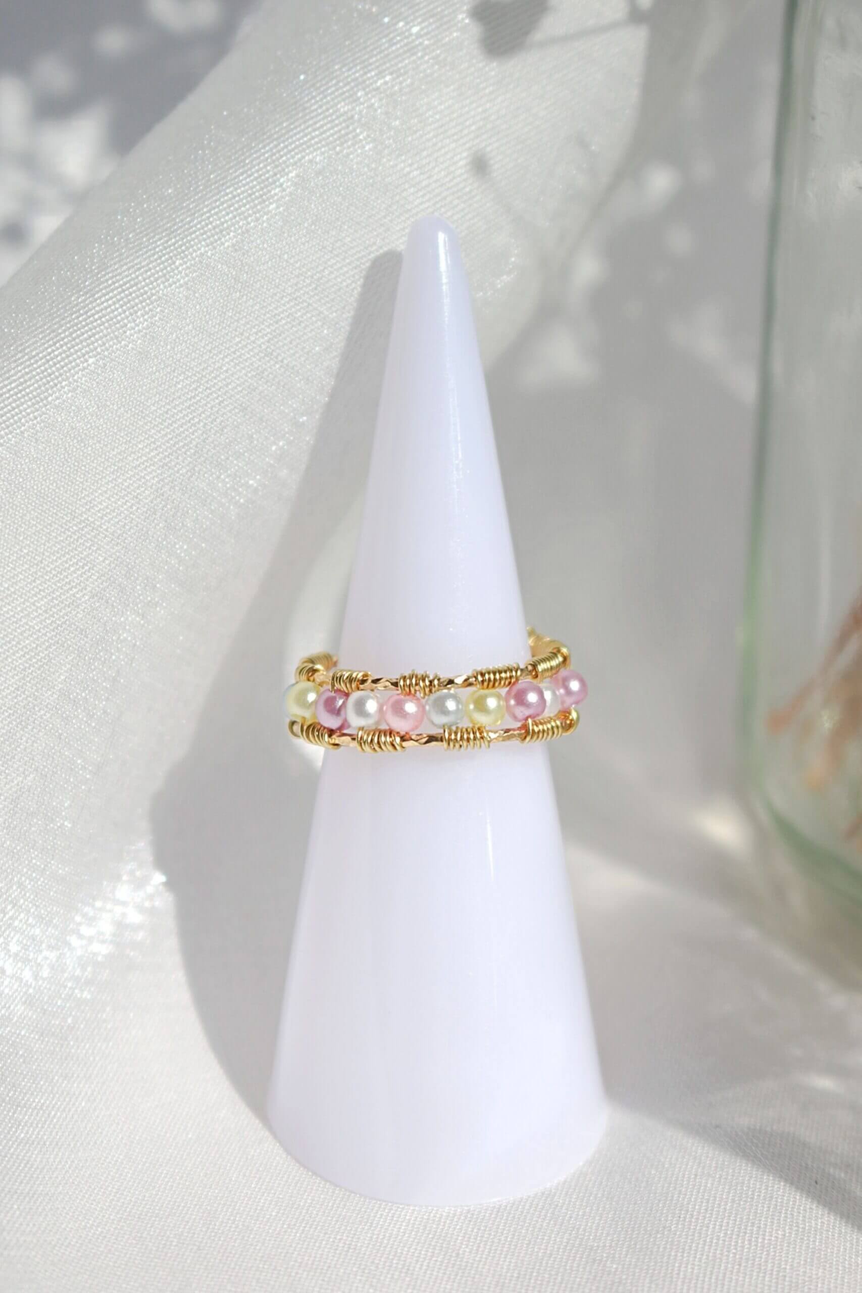 18 Karat Pastel Rainbow Hand Wired Band Ring by Ultramarine Birch, featuring colorful pastel gemstones and intricate wire wrapping.