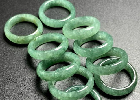 Green jade stone finger ring by Rose Broadleaf featuring a polished jade band on a person&