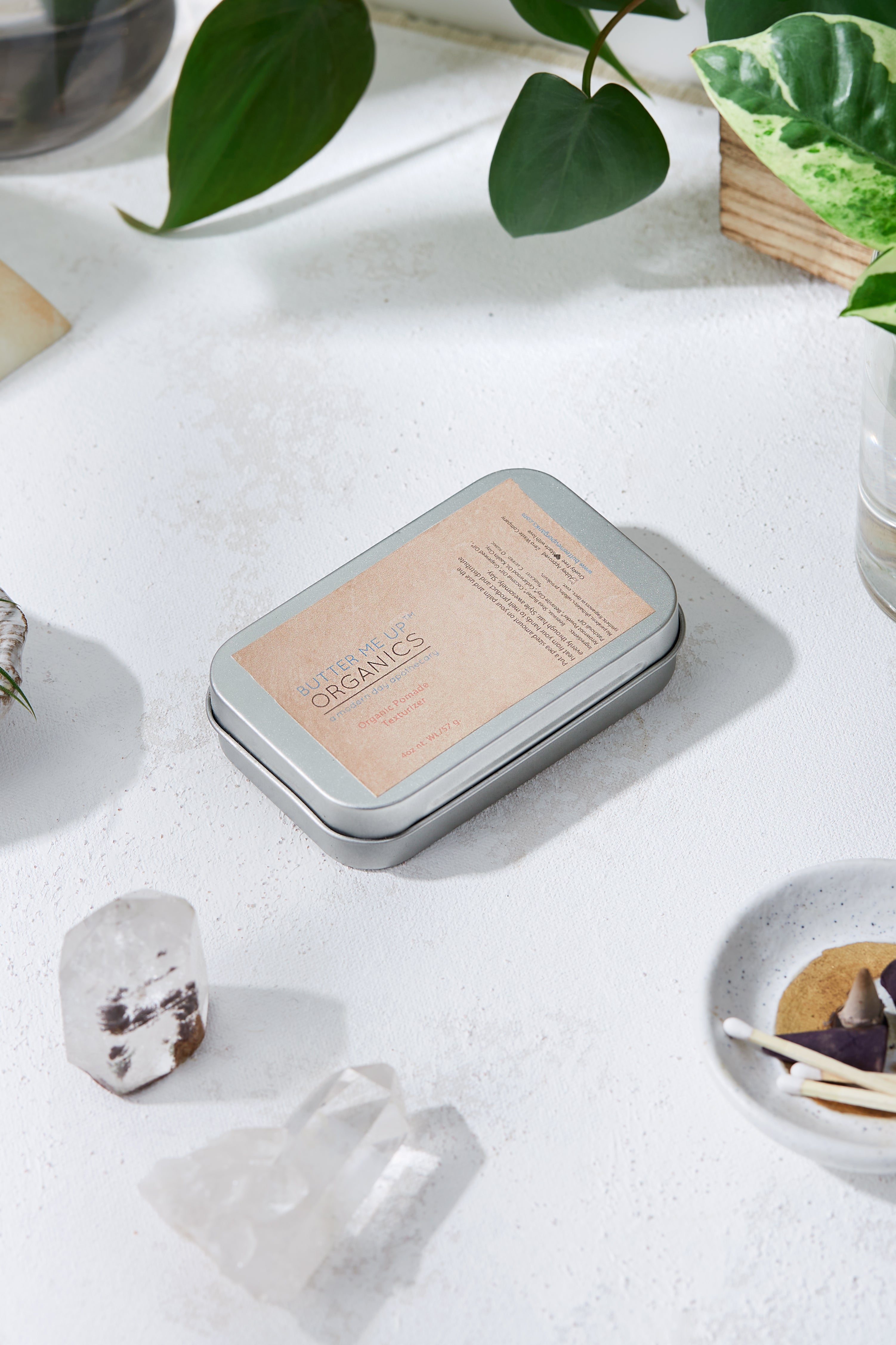 White Smokey Organic Pomade Hair Wax styling gel in a jar, showing smooth, natural hair with a glossy finish.