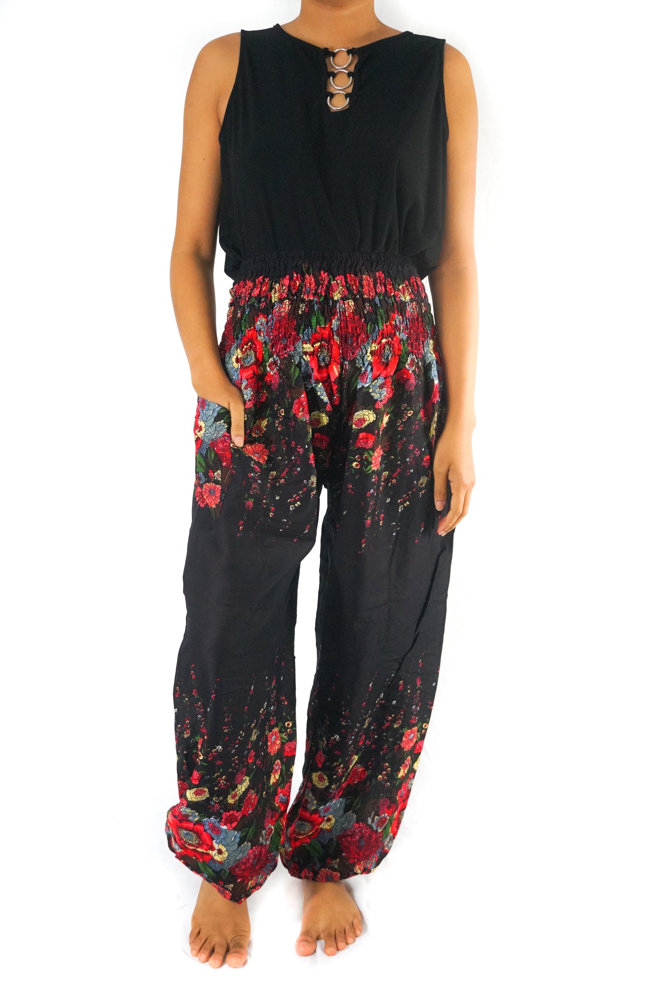 Black floral boho yoga pants for women by Tan Smokey, featuring a flowy, relaxed fit with vibrant flower patterns.