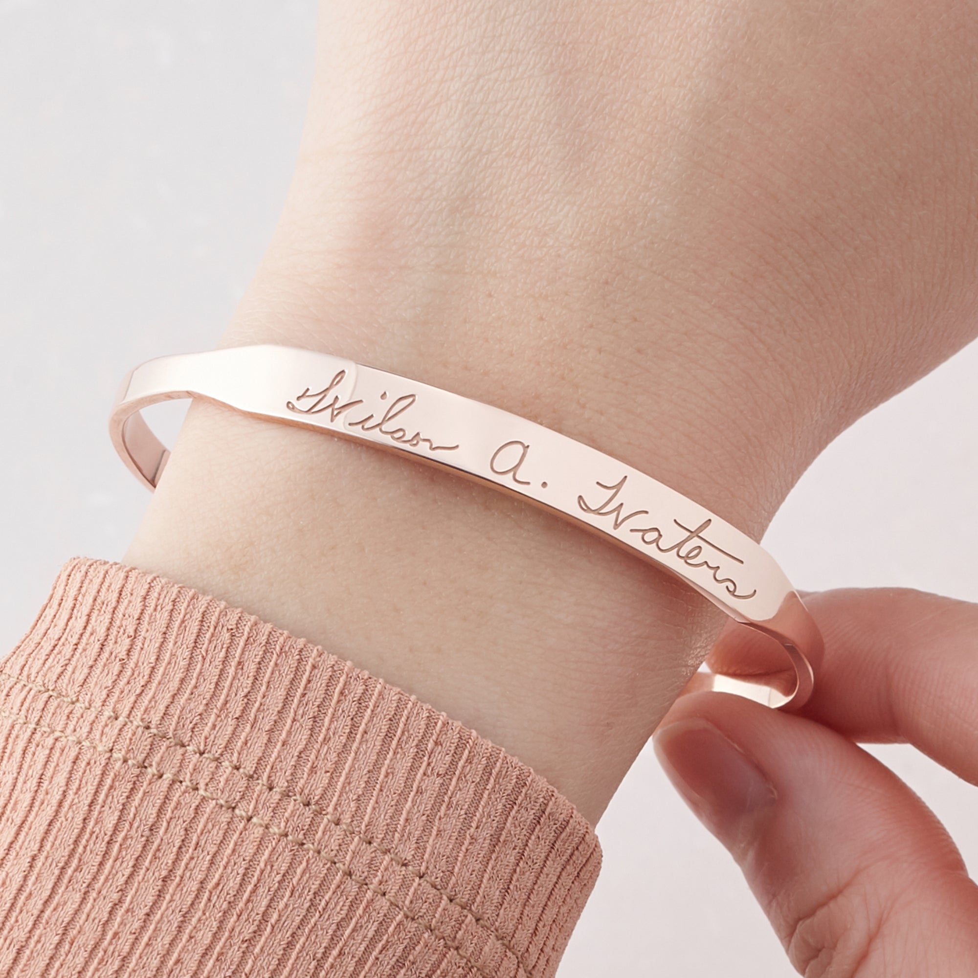 Green Millie handwritten cuff bracelet cufflinks with engraved script, silver-tone metal and detailed design.