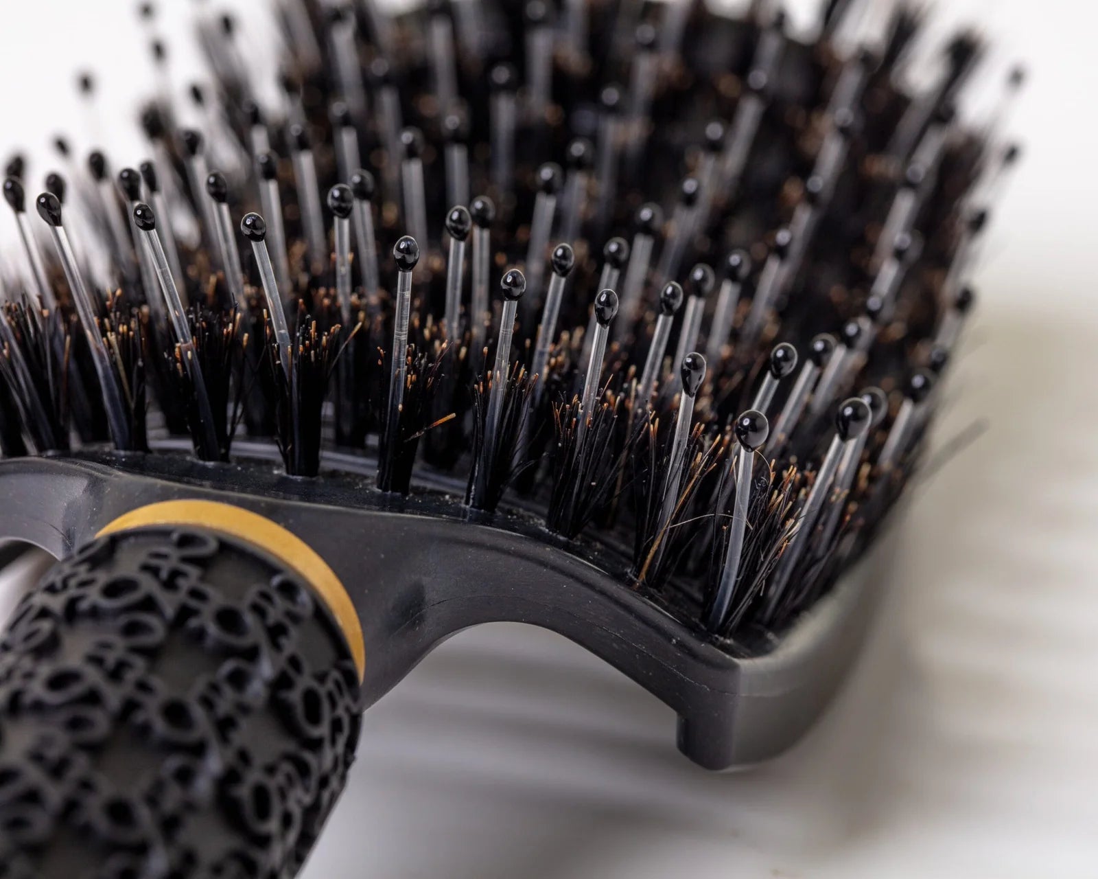 Black Burgundy Clover hair comb with wide teeth, ideal for detangling and styling hair.