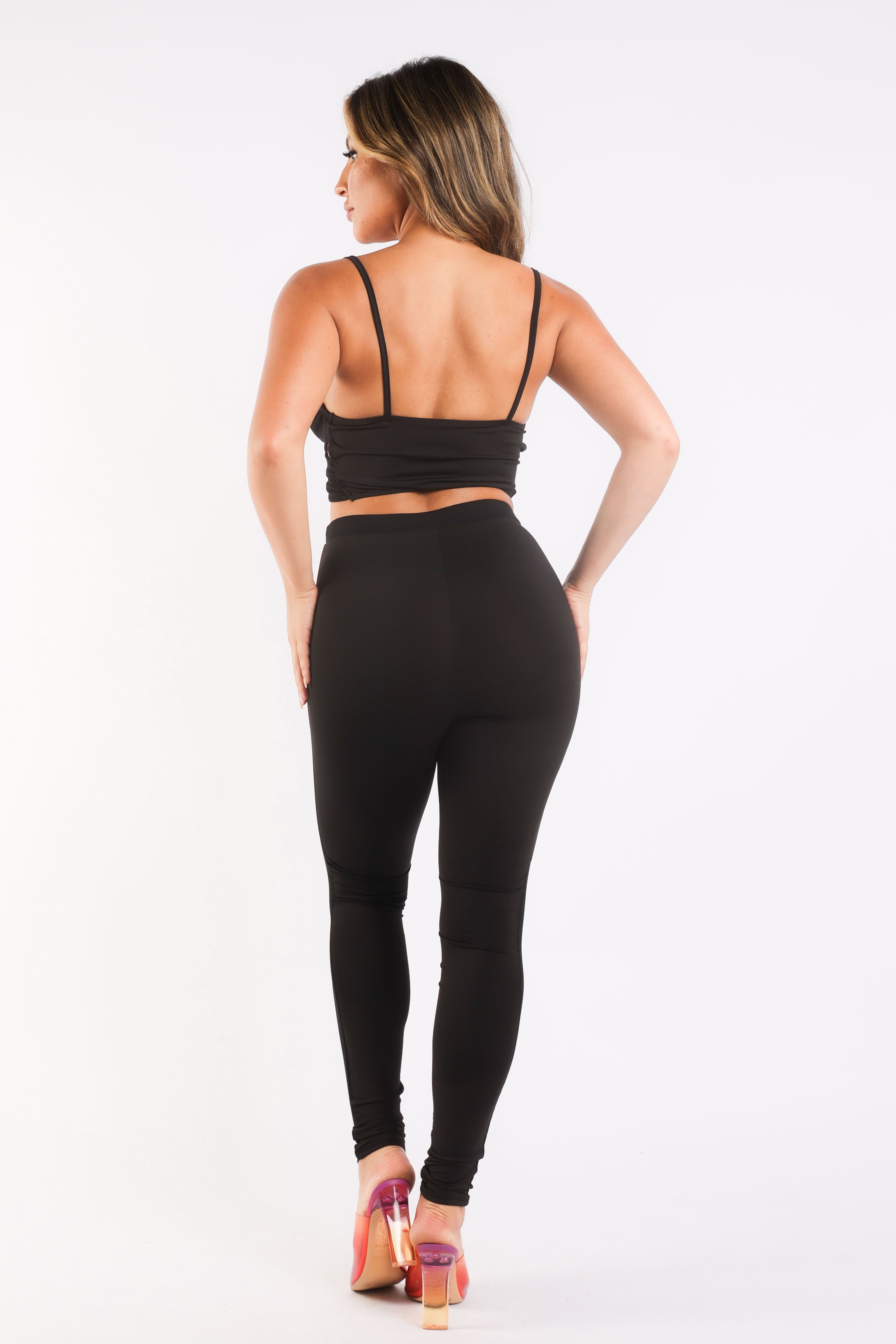 Black mesh contrast sports set by Puce Juniper, includes strappy sleeve top and matching leggings for casual athletic wear.