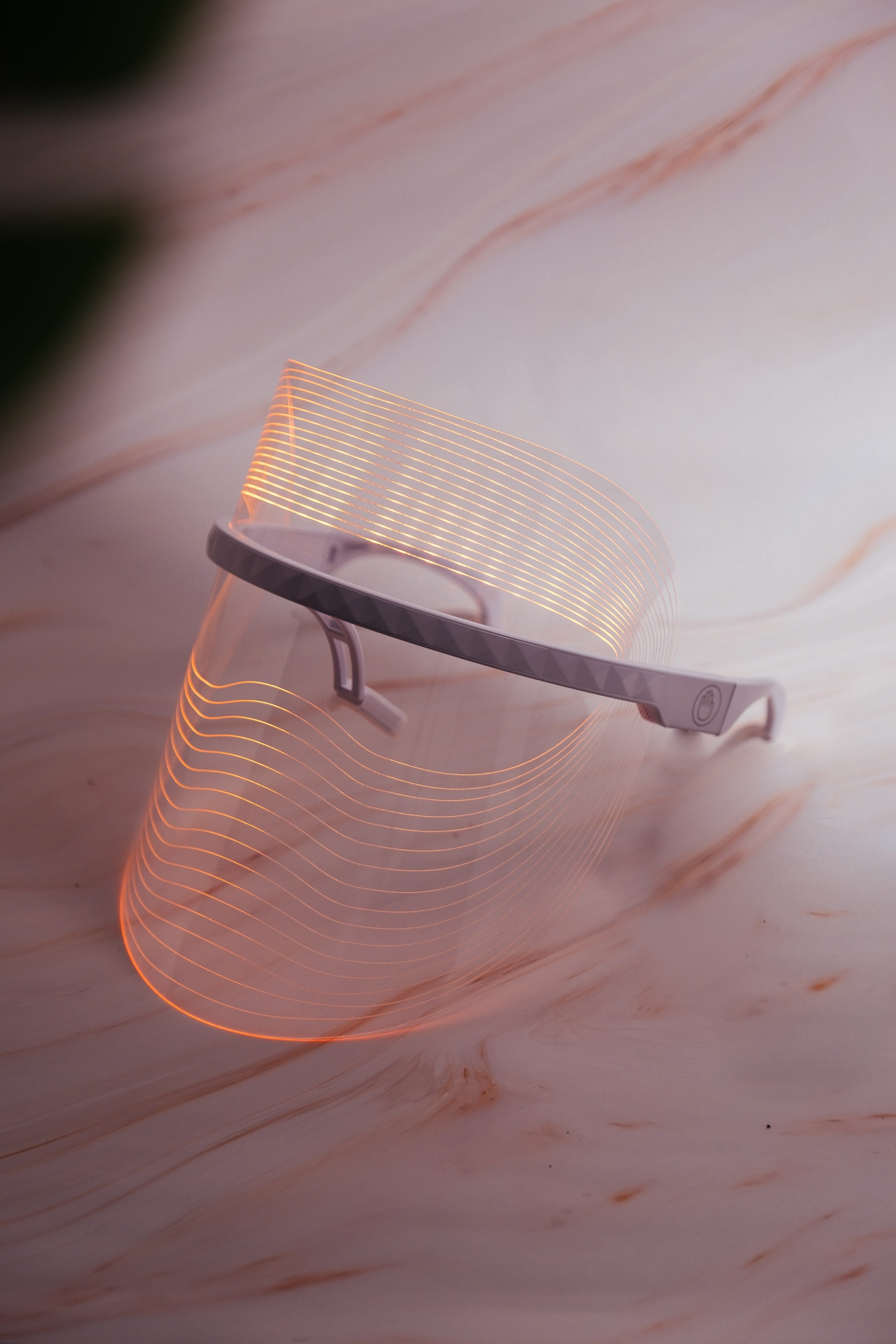 Scarlet Chrysippus Cocoon Skin Enlightenment LED Face Mask with adjustable straps and multiple light therapy panels on a white background.