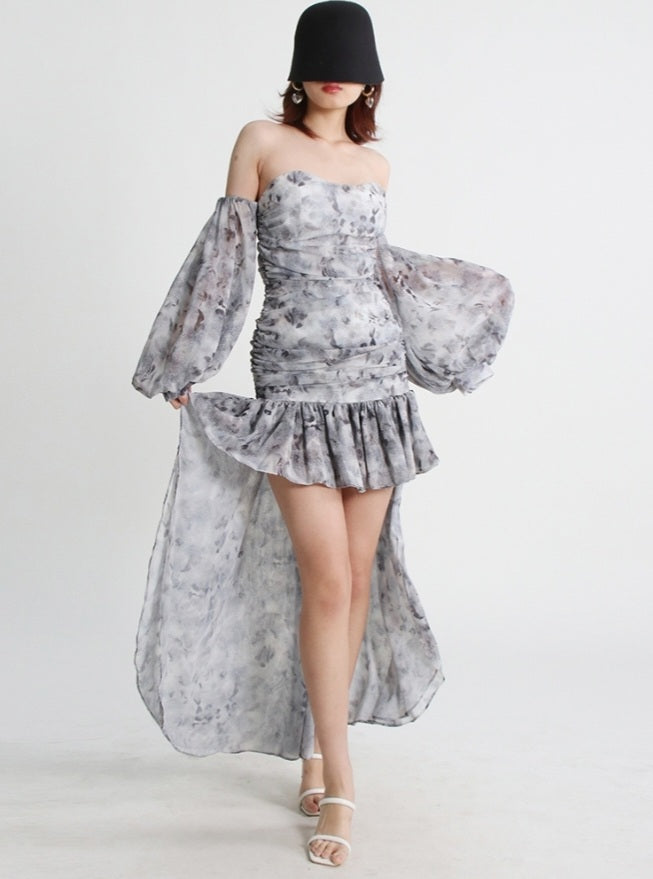 Mauve Ananke asymmetrical mini dress with slash neckline and puff sleeves, solid minimalist design, worn by a model.