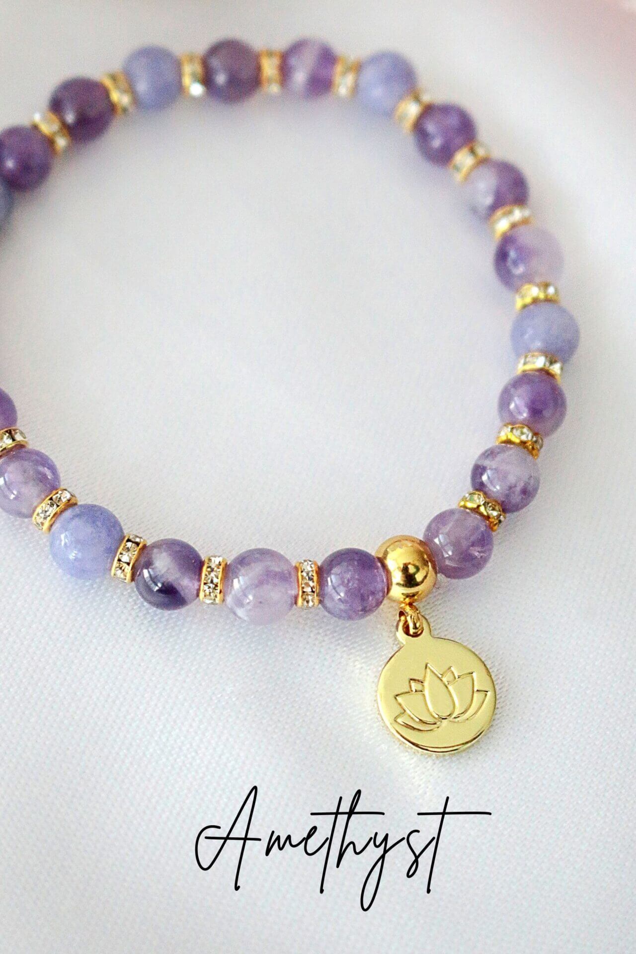 Ultramarine Birch rose quartz and amethyst elastic bracelet with a 24K lotus flower charm, featuring polished gemstone beads.