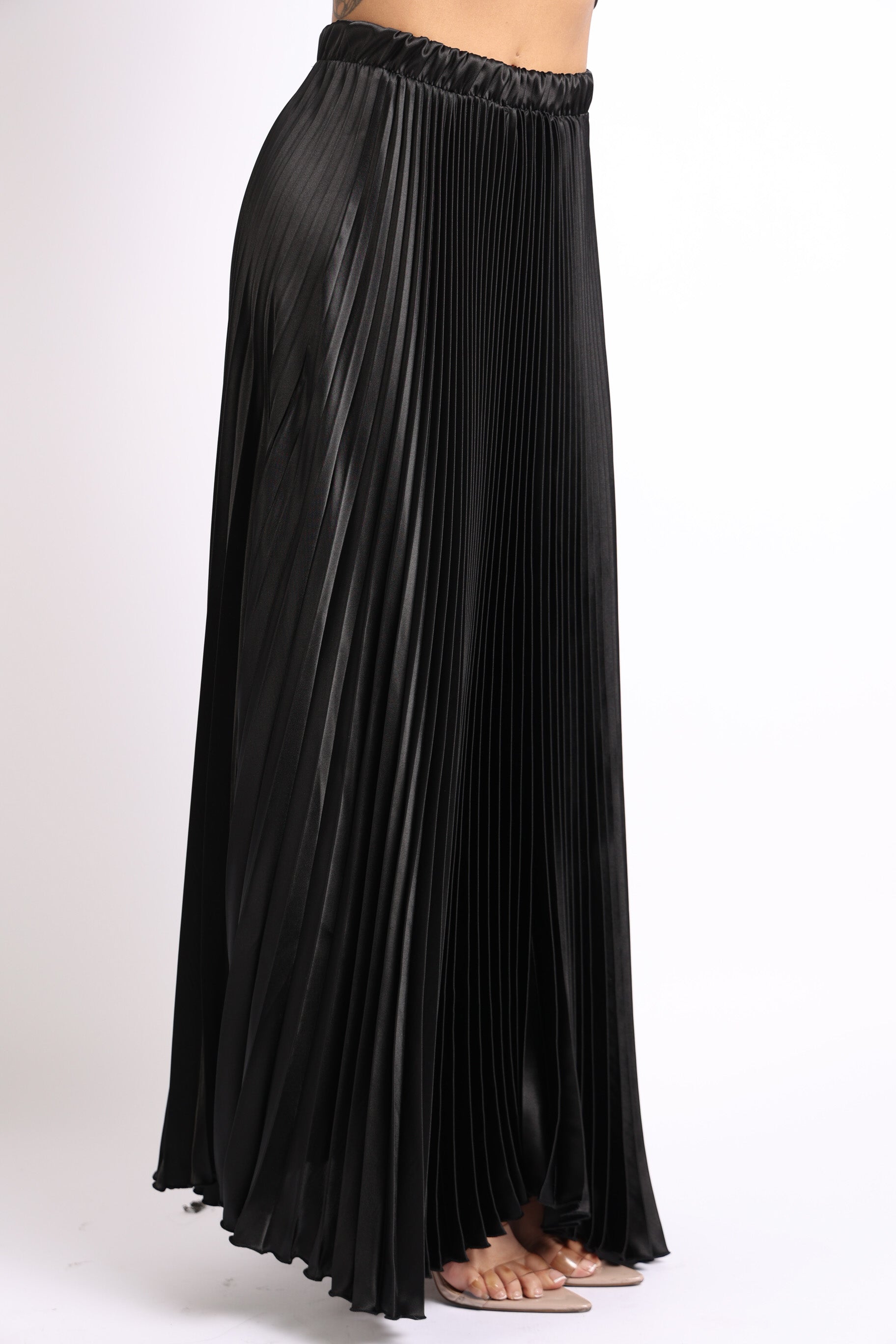 Black satin maxi skirt with elastic high waist and pleated A-line design from Puce Juniper, perfect for formal or prom occasions.