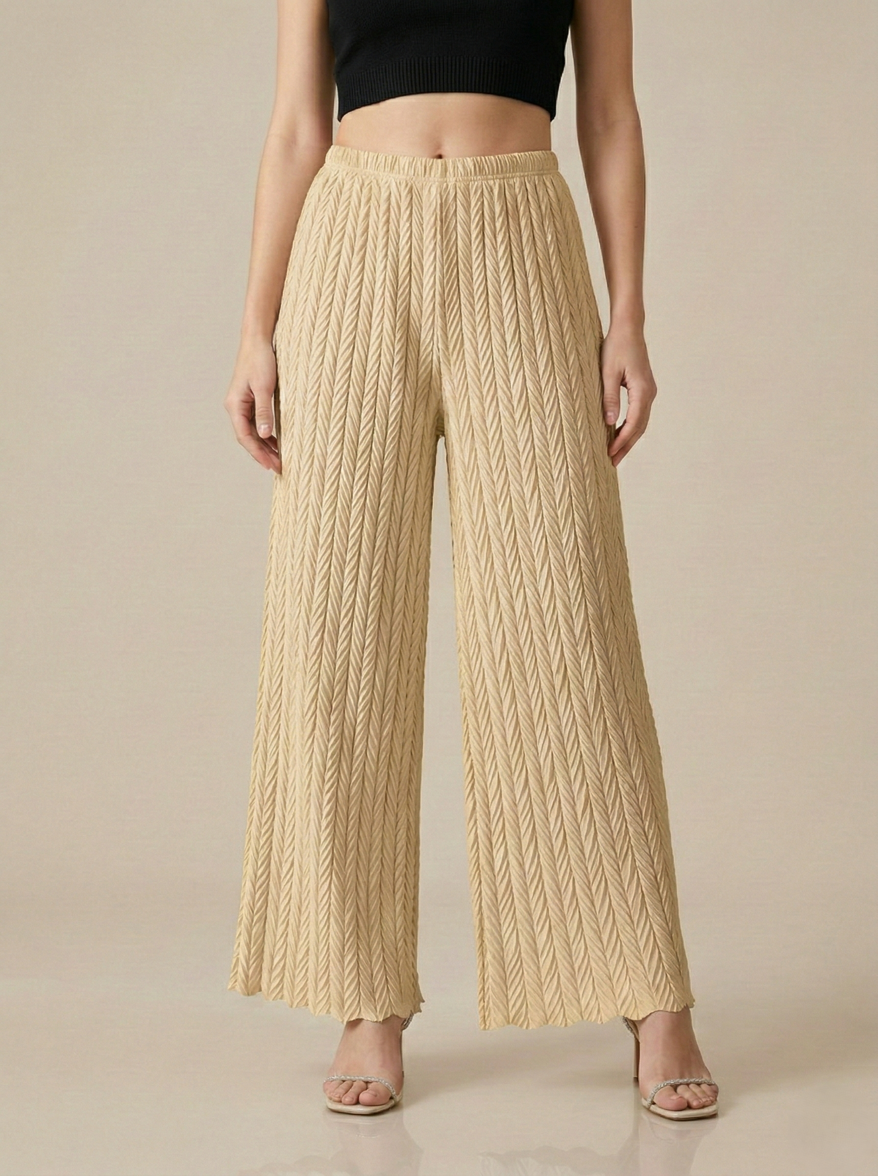 Textured pleated palazzo pants for women by Apricot Dione, showing the wide-leg, flowy fabric and pleated design.