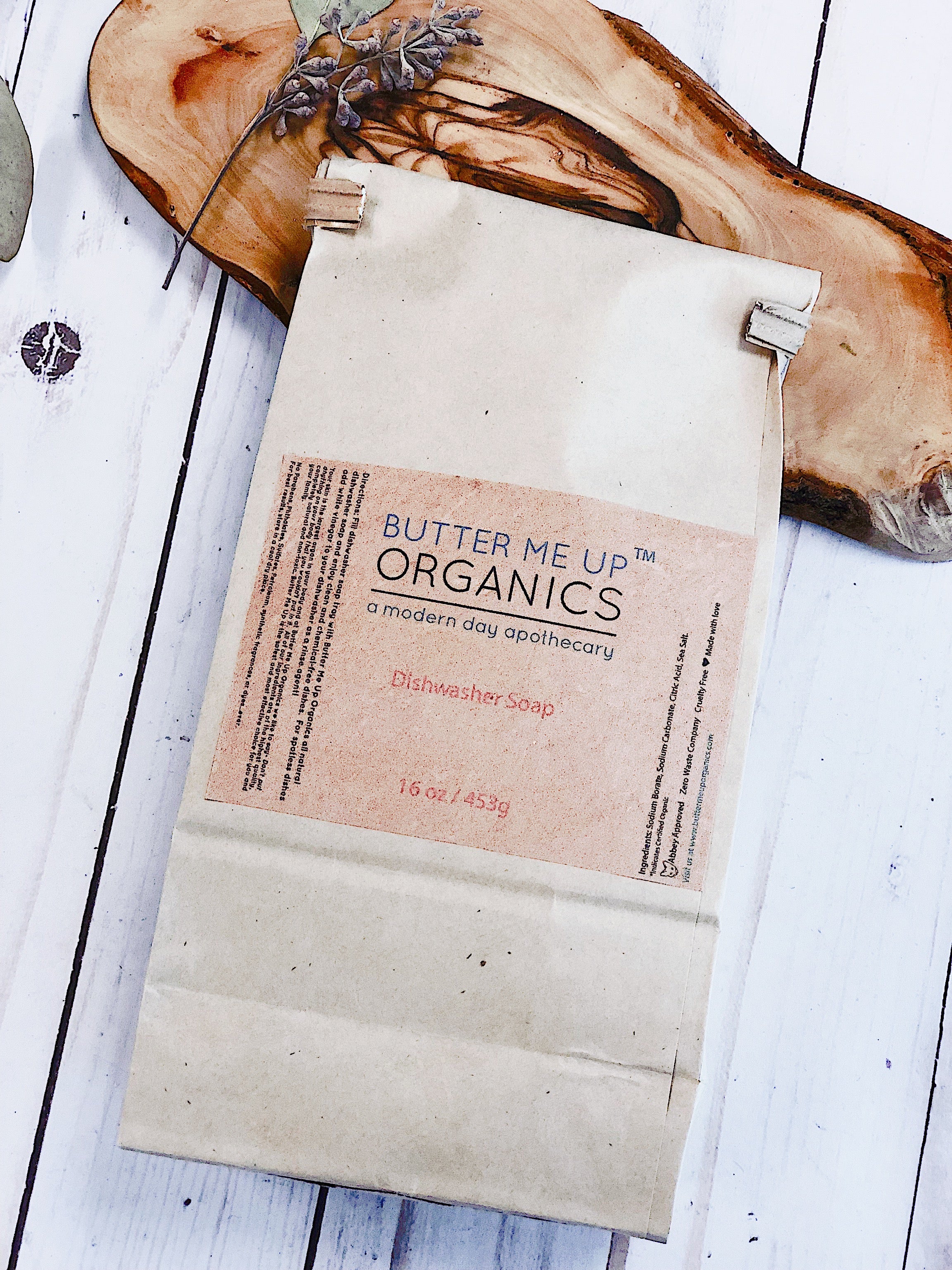 White Smokey all natural dishwasher soap in a kitchen setting, showing the eco-friendly detergent container.