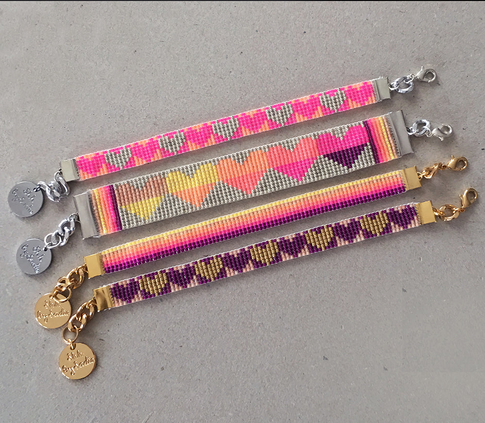 Colorful rainbow heart bracelets by Yellow Athena featuring vibrant heart charms on stretchy band for stylish wear.