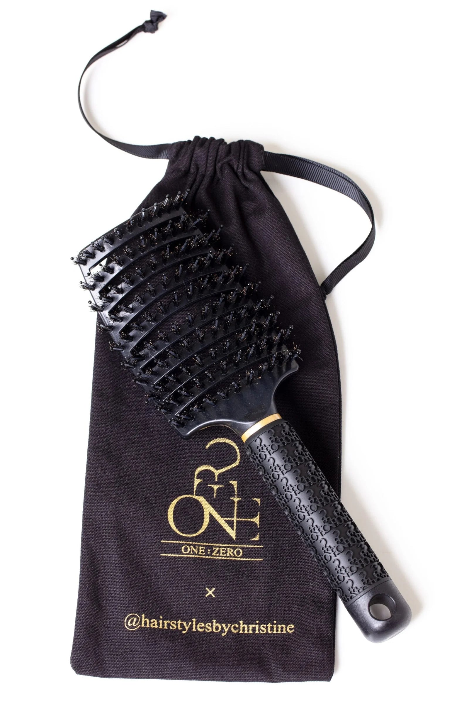 Black Burgundy Clover hair comb for haircare, with wide teeth and sleek design for detangling and styling hair.
