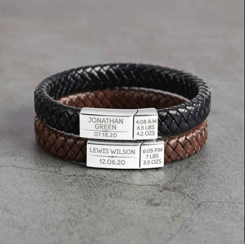 Green Millie baby footprint bracelet for new dads, featuring a silver bracelet with engraved baby footprint design.