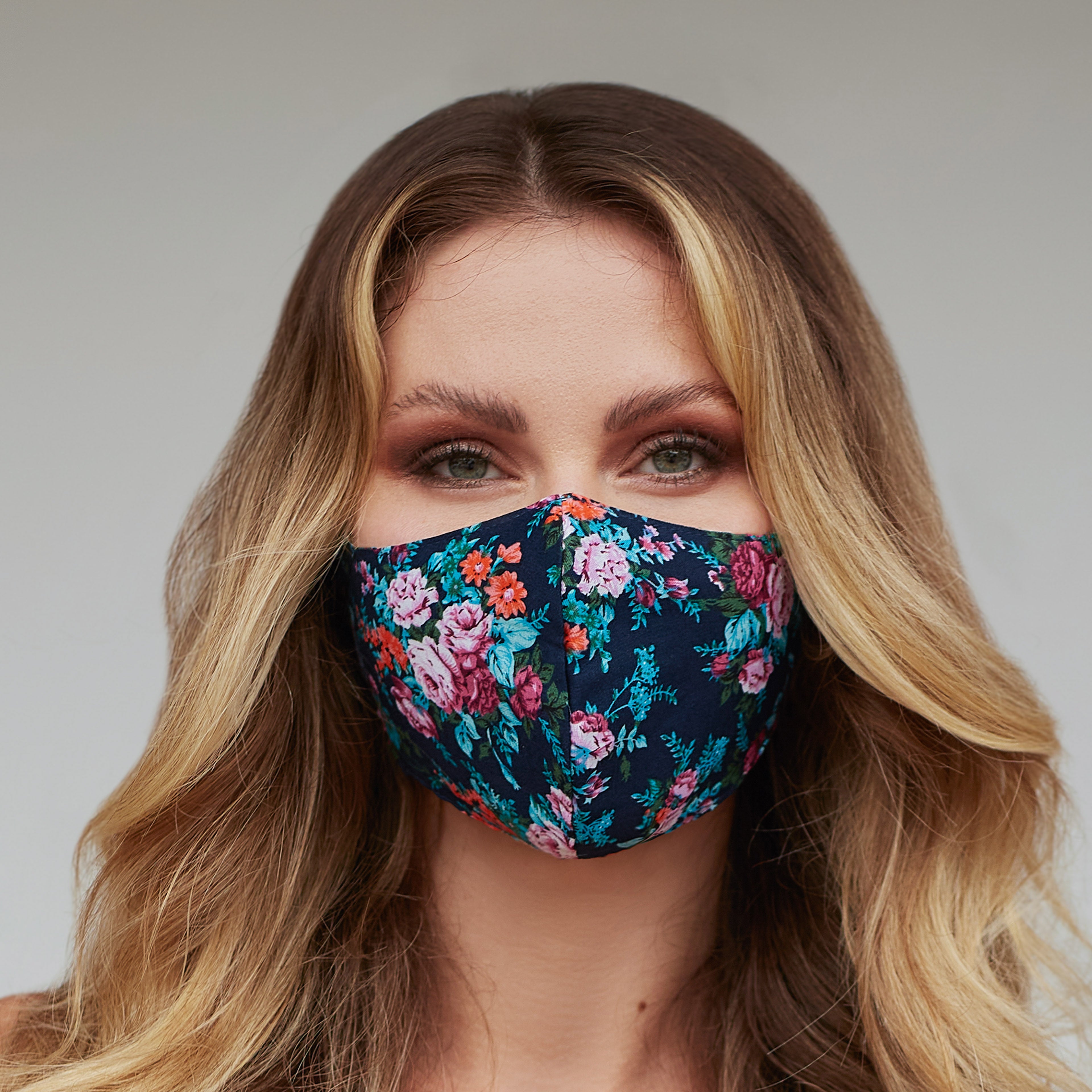 Turquoise floral face mask for women by Cyan Poppy, featuring a vibrant floral pattern and comfortable fabric.