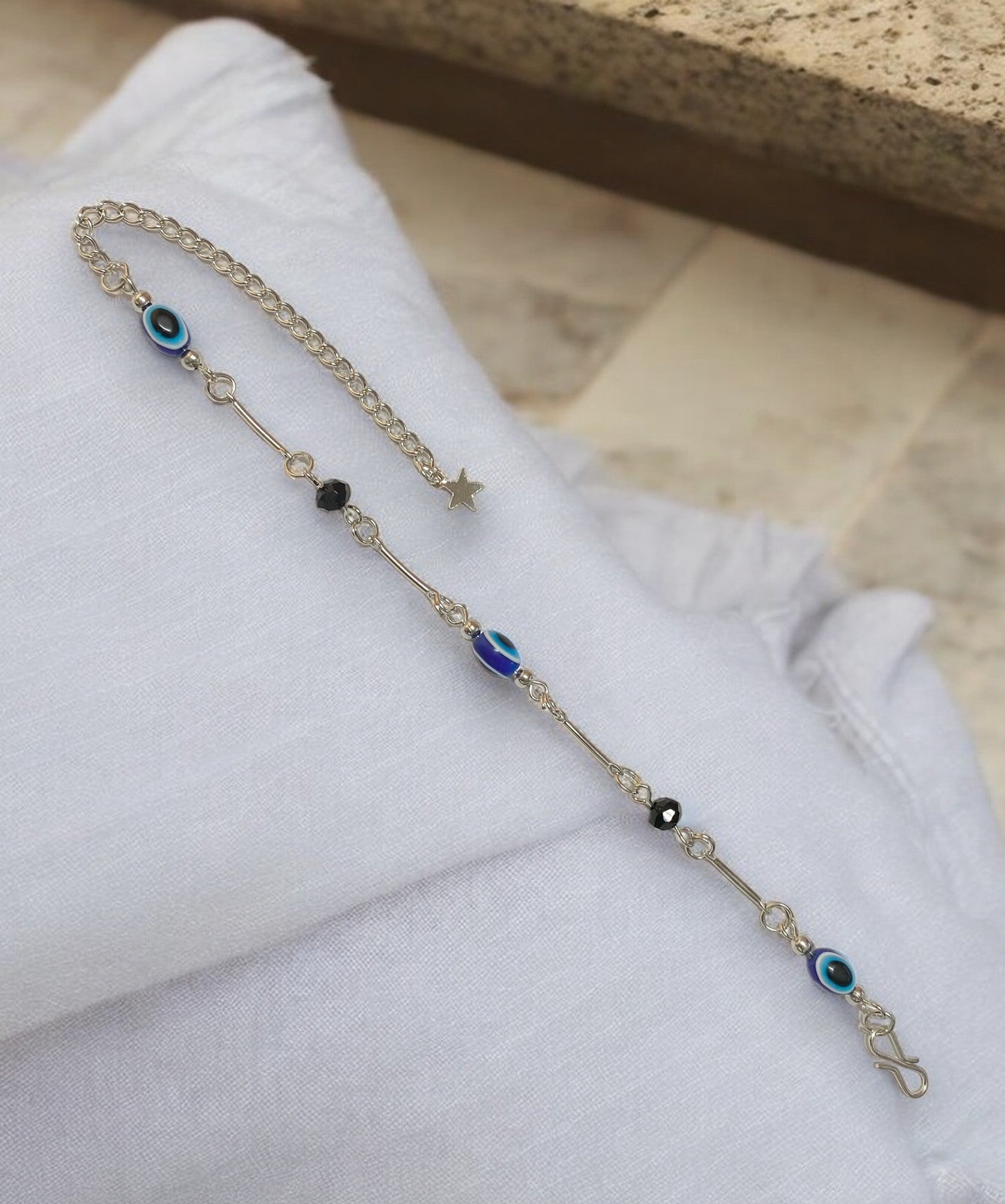 Gray Poseidon Fortune’s Shield Evil Eye bracelet featuring a silver-tone jewelry design with protective evil eye charm.