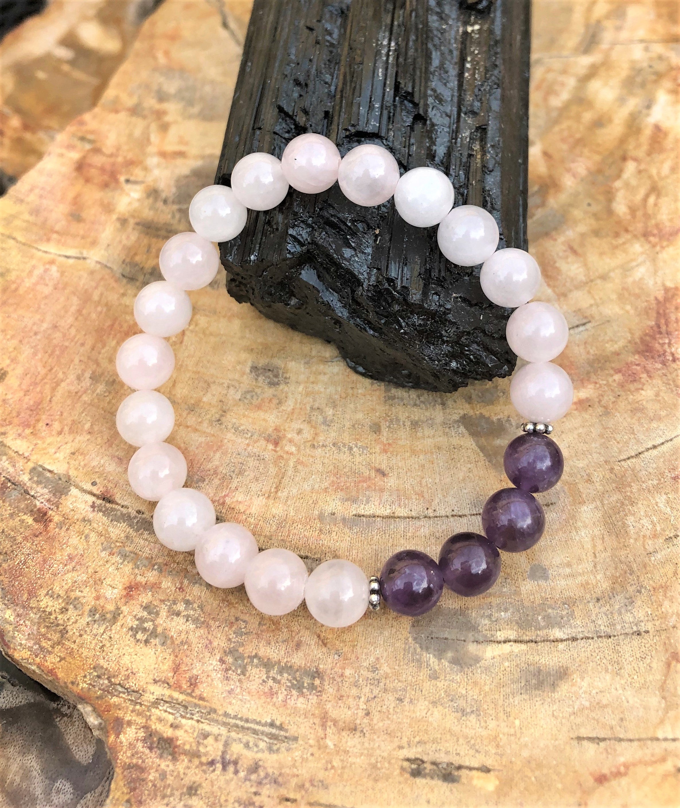 Rose Quartz and Amethyst stretch bracelet by Violet Chaos featuring natural crystal beads on a clear elastic cord.