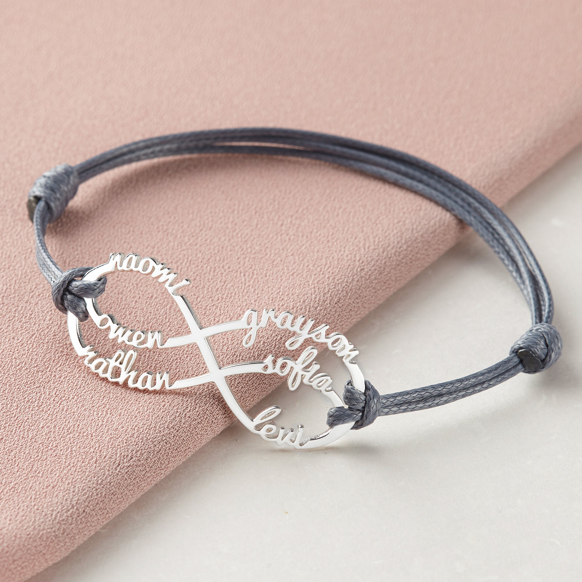 Green Millie mom bracelet featuring infinity design with engraved kids&