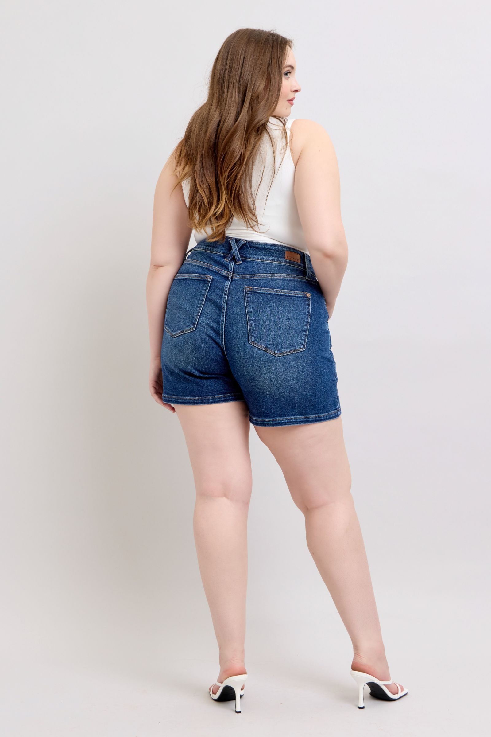 Judy Blue plus size denim shorts with double button waistband, showcasing stylish automotive-inspired design and fit.