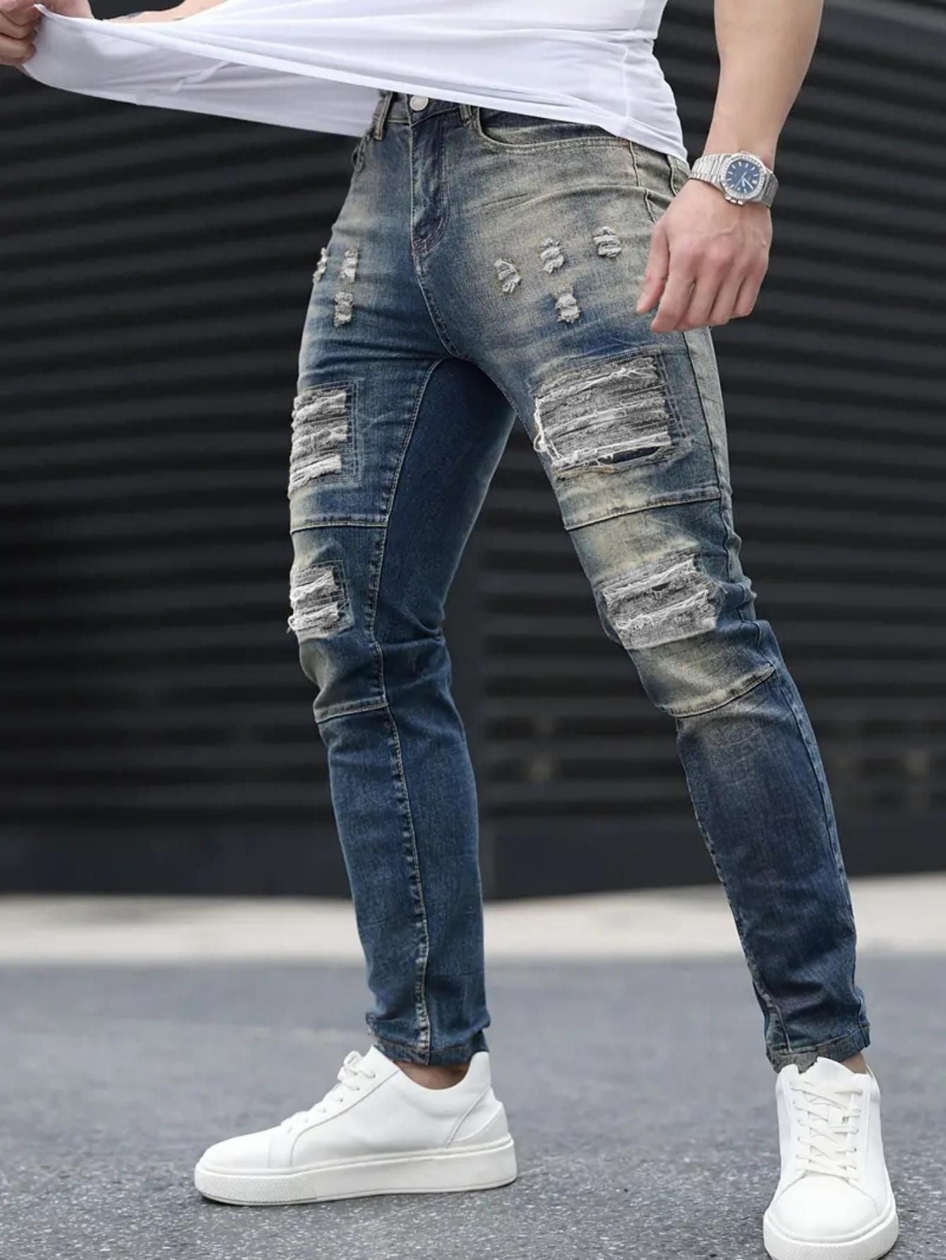 Men’s navy ripped stretch jeans by Carmine Juneberry, stylish high street denim with distressed details and a slim fit.