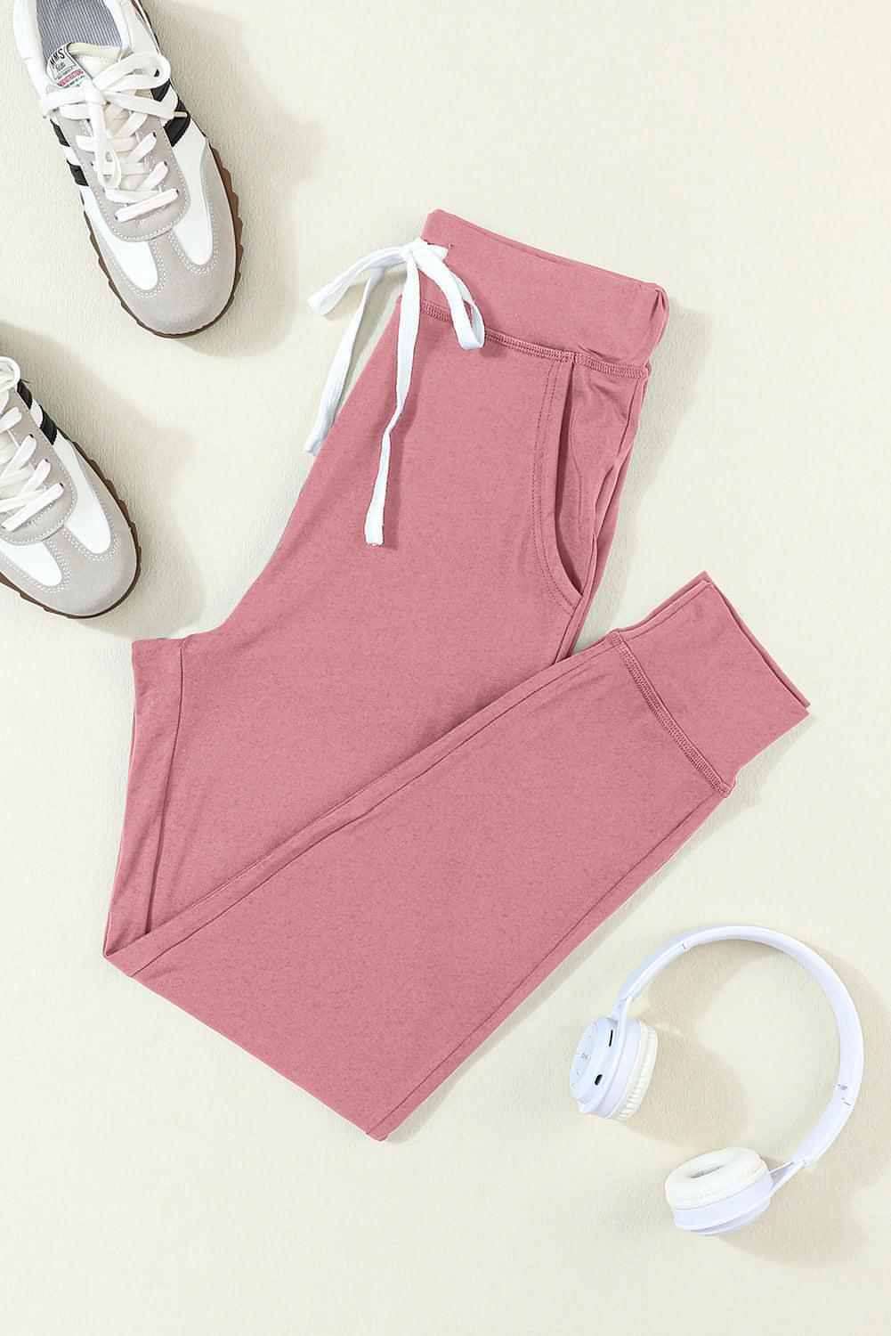 Pink drawstring waist joggers with side pockets, Carmine Juneberry activewear pants for comfortable exercise and casual wear.