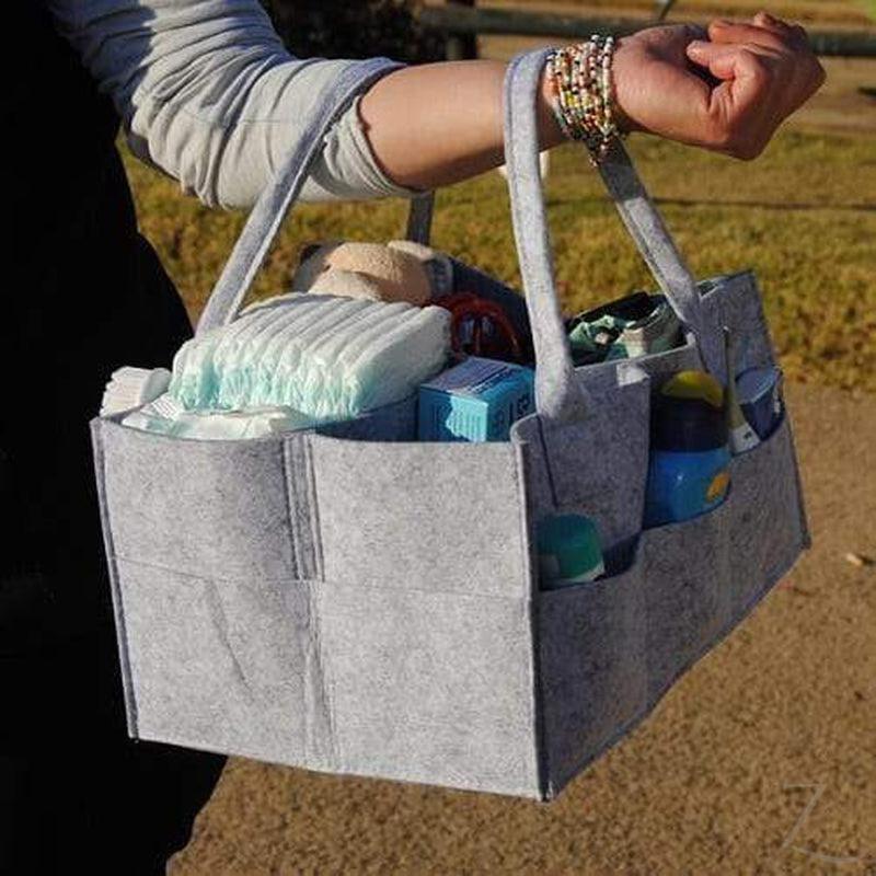 Grey felt nappy organizer caddy by Raspberry Pallas with multiple compartments for baby essentials and diaper storage.