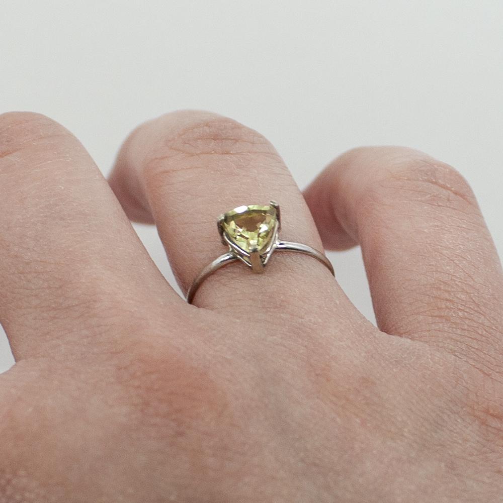 Sterling silver Lemon Topaz trillion solitaire ring with a faceted lemon-colored gemstone on a polished band.
