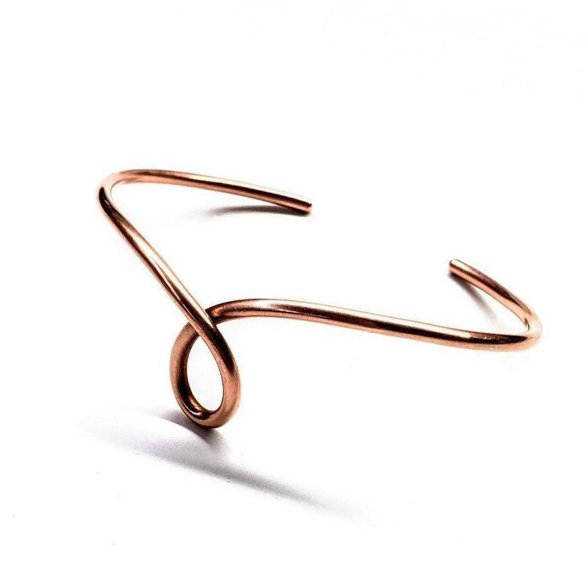Handmade sculpted copper teardrop bangle bracelet by Blue Crius featuring intricate detailing and a polished finish.