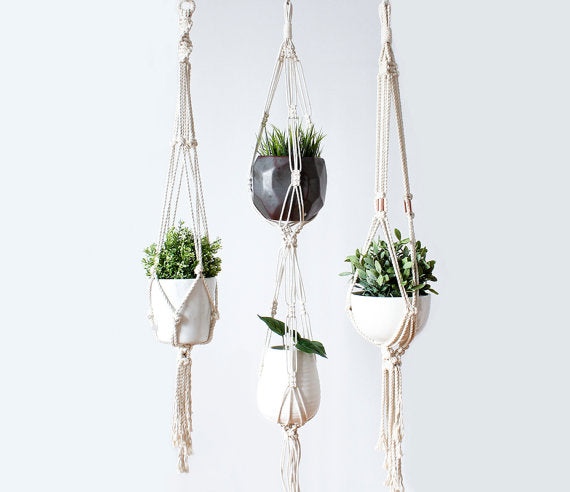 Silver Simba macrame plant hanger for indoor and outdoor use, featuring intricate knotted design and space for potted plants.