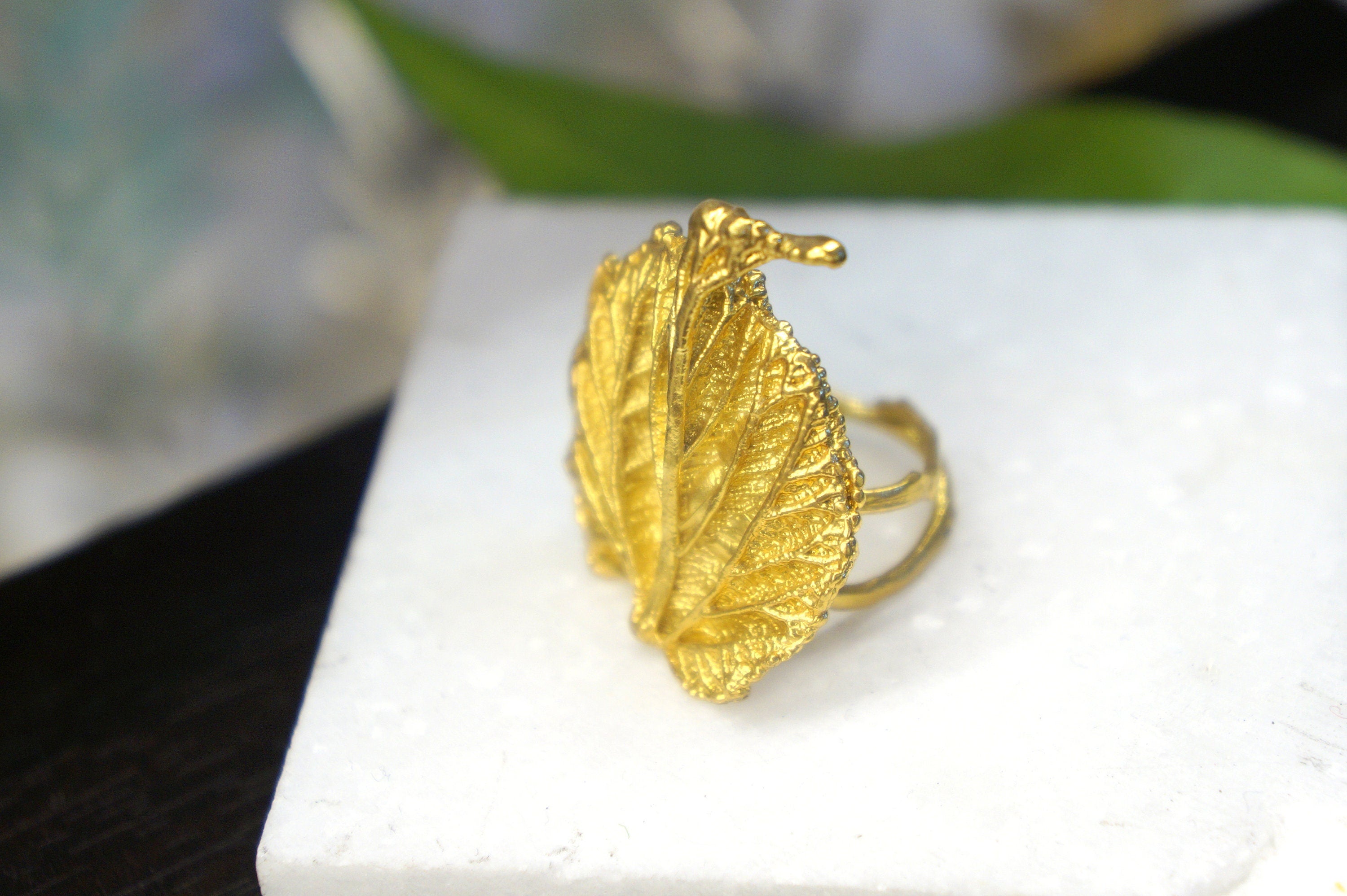 Handmade gold-plated sterling silver leaf ring with intricate leaf design, part of Beige Briseis jewelry collection