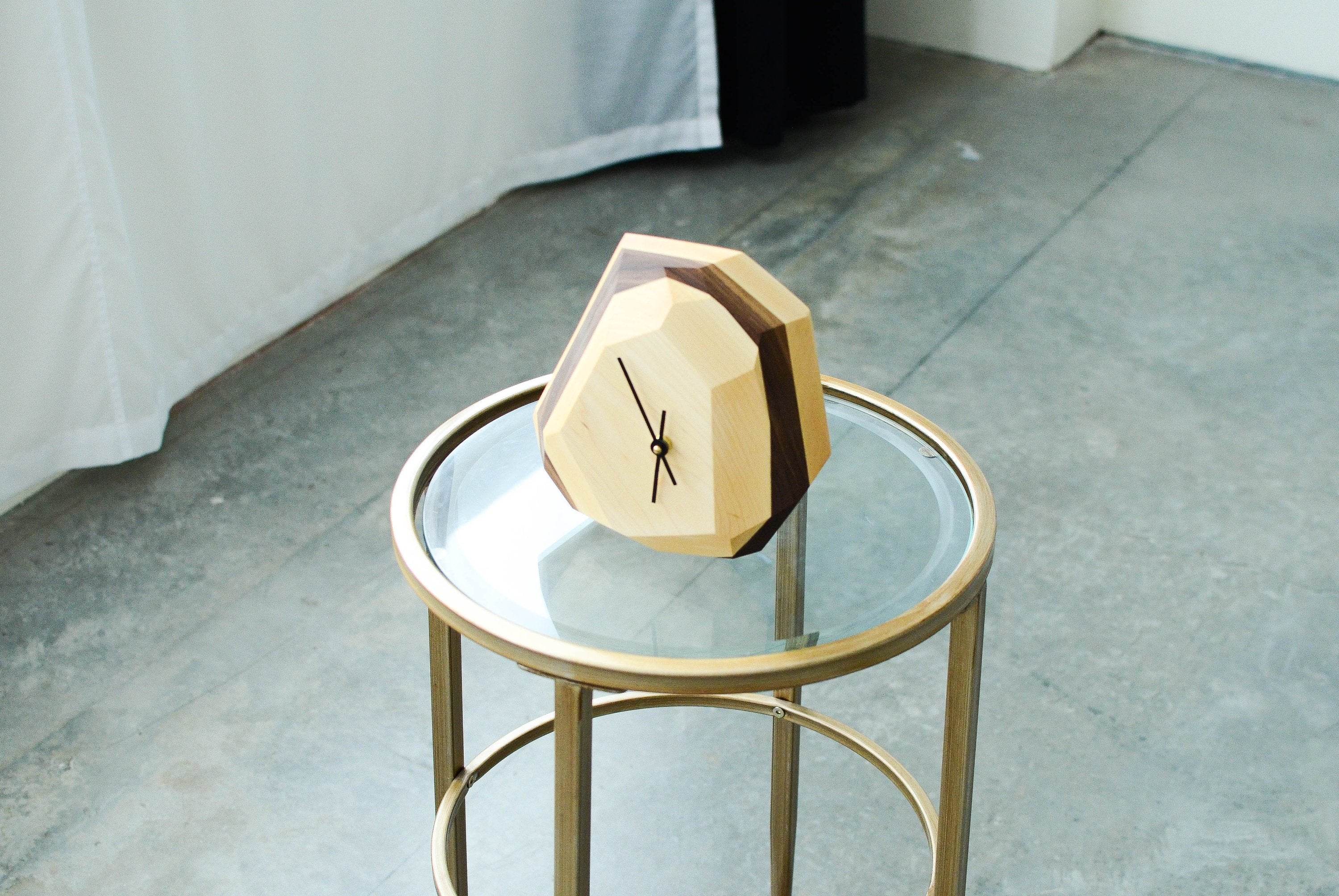 Pinwheel geometric wall and table clock with modern design, featuring bold shapes and a sleek finish for stylish home decor.